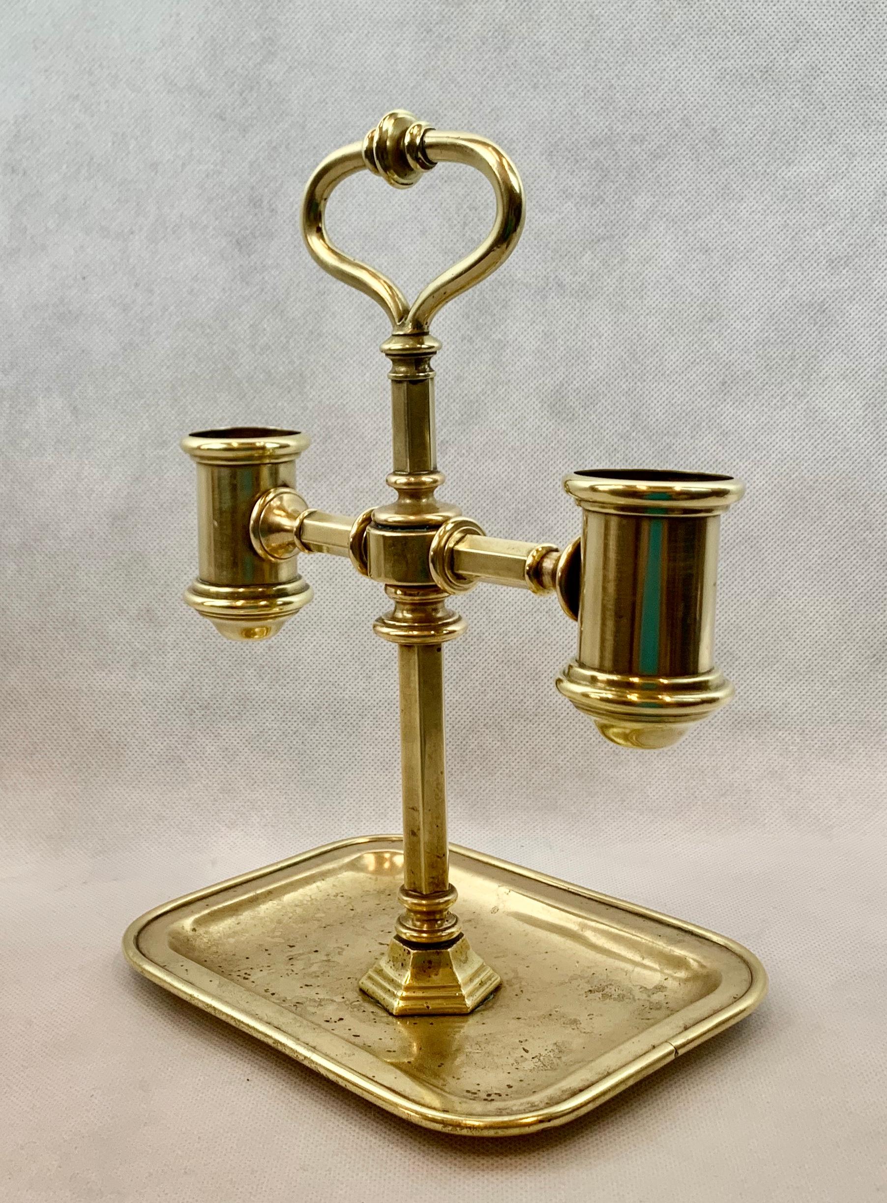 Handsome solid brass double candlstand with attached tray. At the top there is a decorative handle for carrying. This piece could also be electrified easily using two small shades or one larger shade.
 (We go through the laborious task of hand