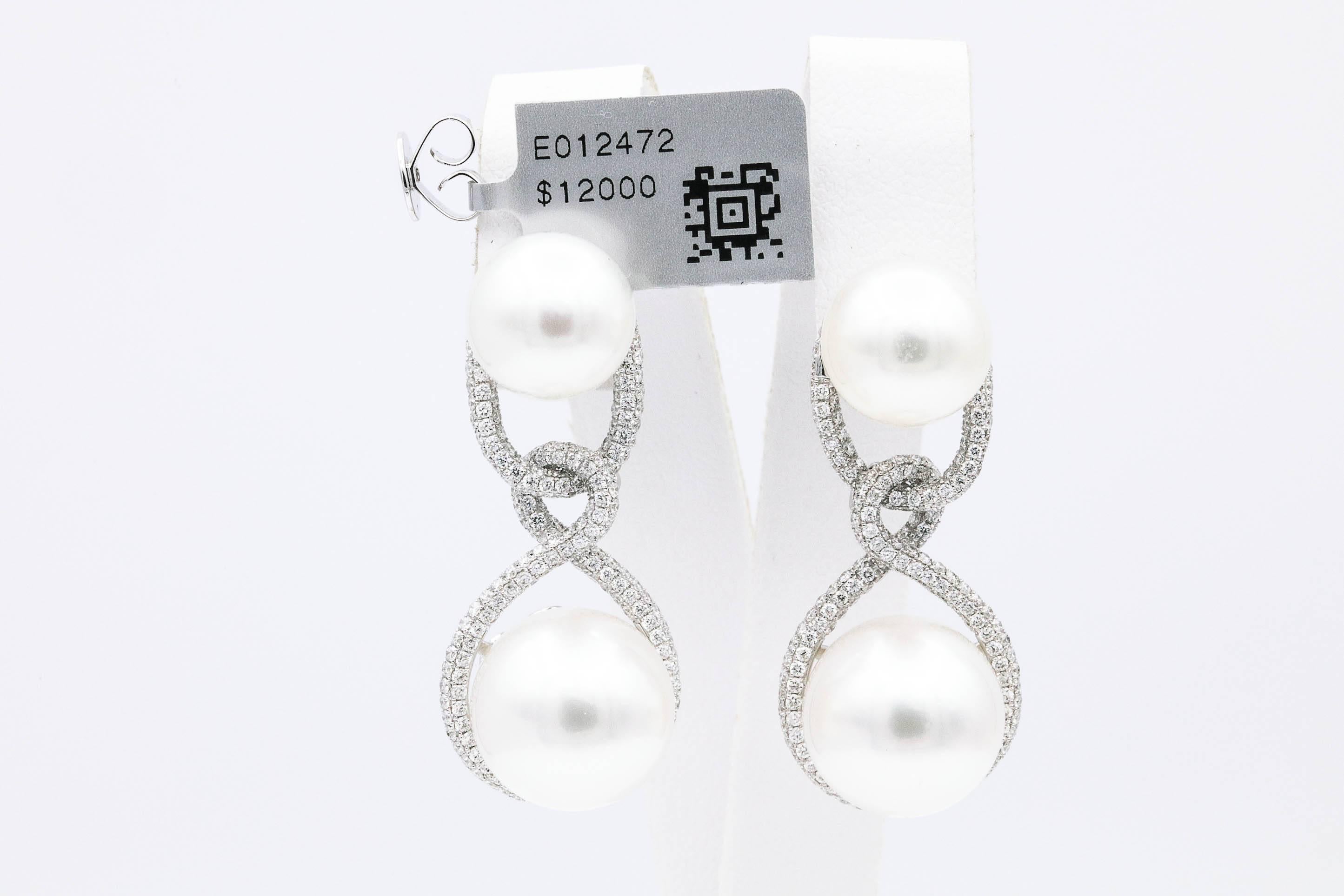 18K White Gold earrings featuring four South Sea Pearls measuring 11-13 MM flanked with numerous diamonds weighing 1.90 Carats. Color G-H Clarity SI