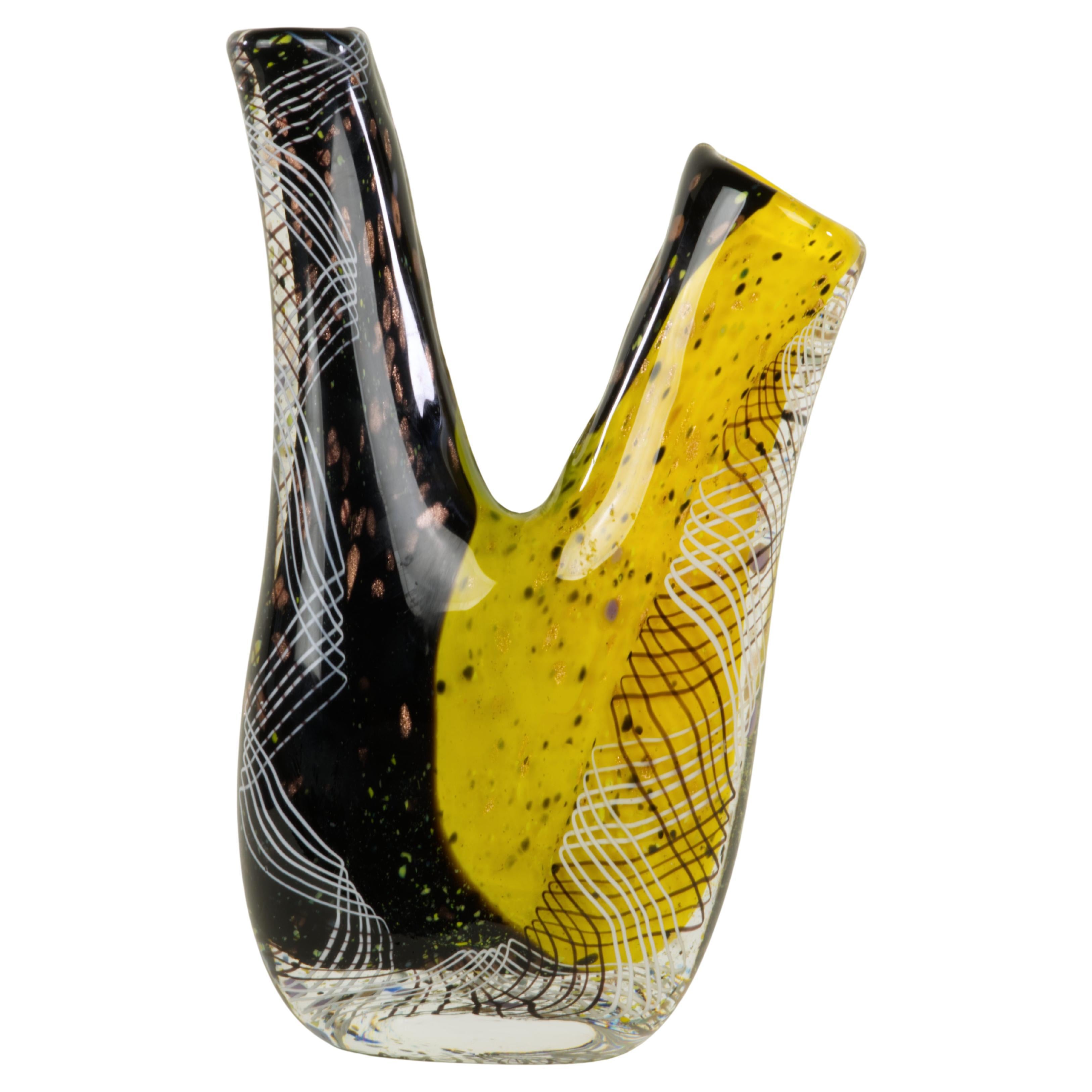 Murano style art glass vase has an unusual double spout shape and is decorated with black and white line swirls and abstract dots and gold flecks pattern on the colorful black and yellow base. It is marked with artist signature and 2005 on the base.