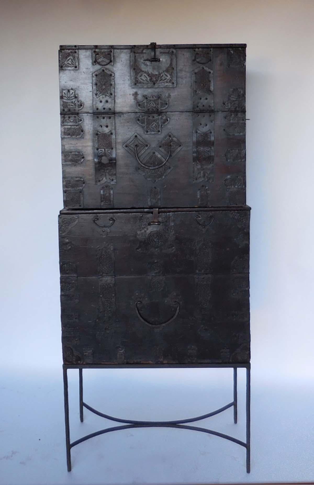 Pair of 18th century Korean Chests stacked atop each other. Intricate metal cutout work decorates the pieces. Some metal repairs have been made is the distant past. Top front panel drops down for storage. The chest are about the same size but the