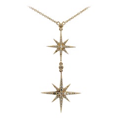 Collana con doppio ciondolo a stella con diamanti da 0,35 carati in oro giallo 14 carati