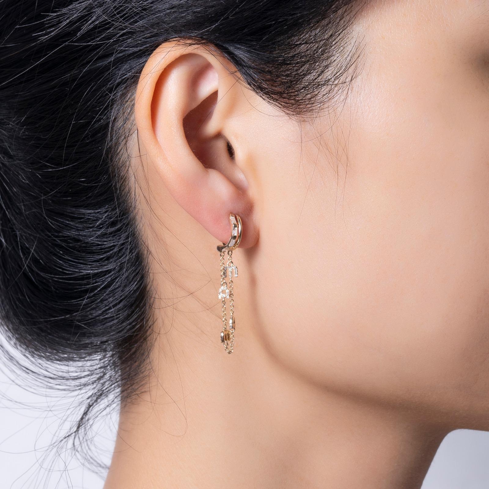 These stunning 14k yellow gold earrings feature a unique combination of round and baguette diamonds, making them a perfect choice for both casual elegance and formal occasions. The radiant yellow gold setting beautifully complements the natural