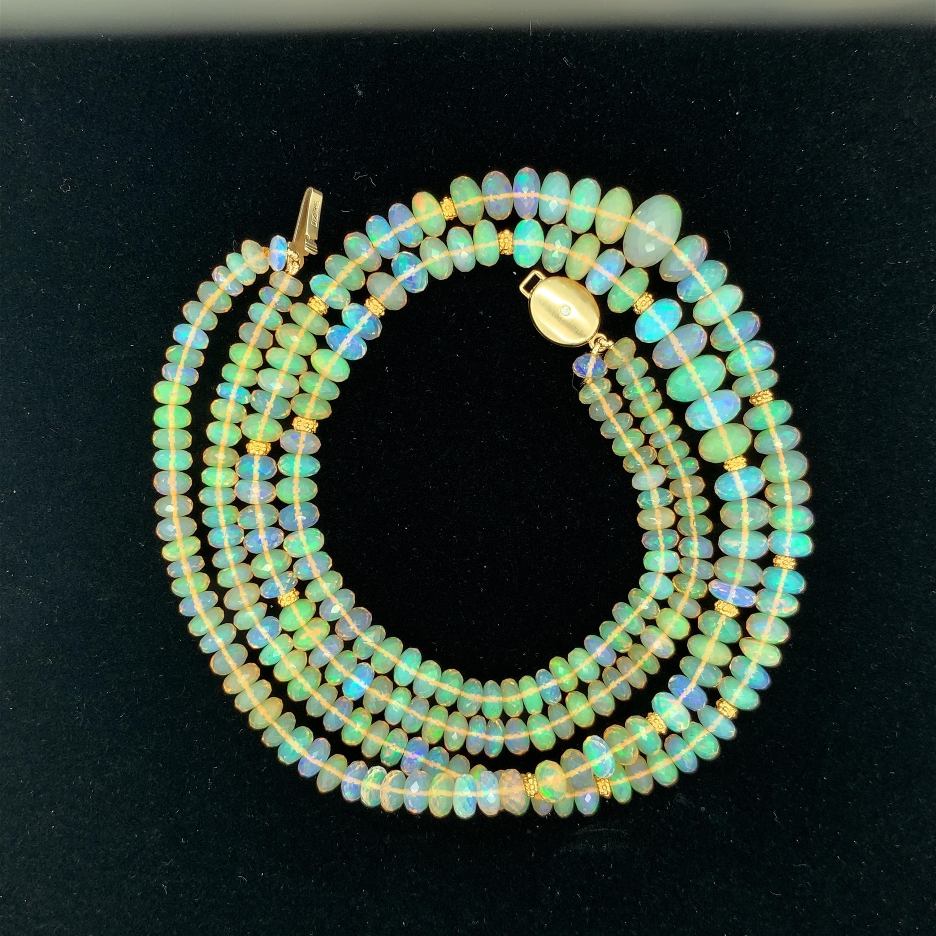 This is an elegant double strand of colorful Ethiopian opal beads weighing 170.45 carats total! The beads are faceted and  graduate in sizes ranging from 11.00mm to 5.00 millimeters. Predominately green, orange, and lavender with flashes of