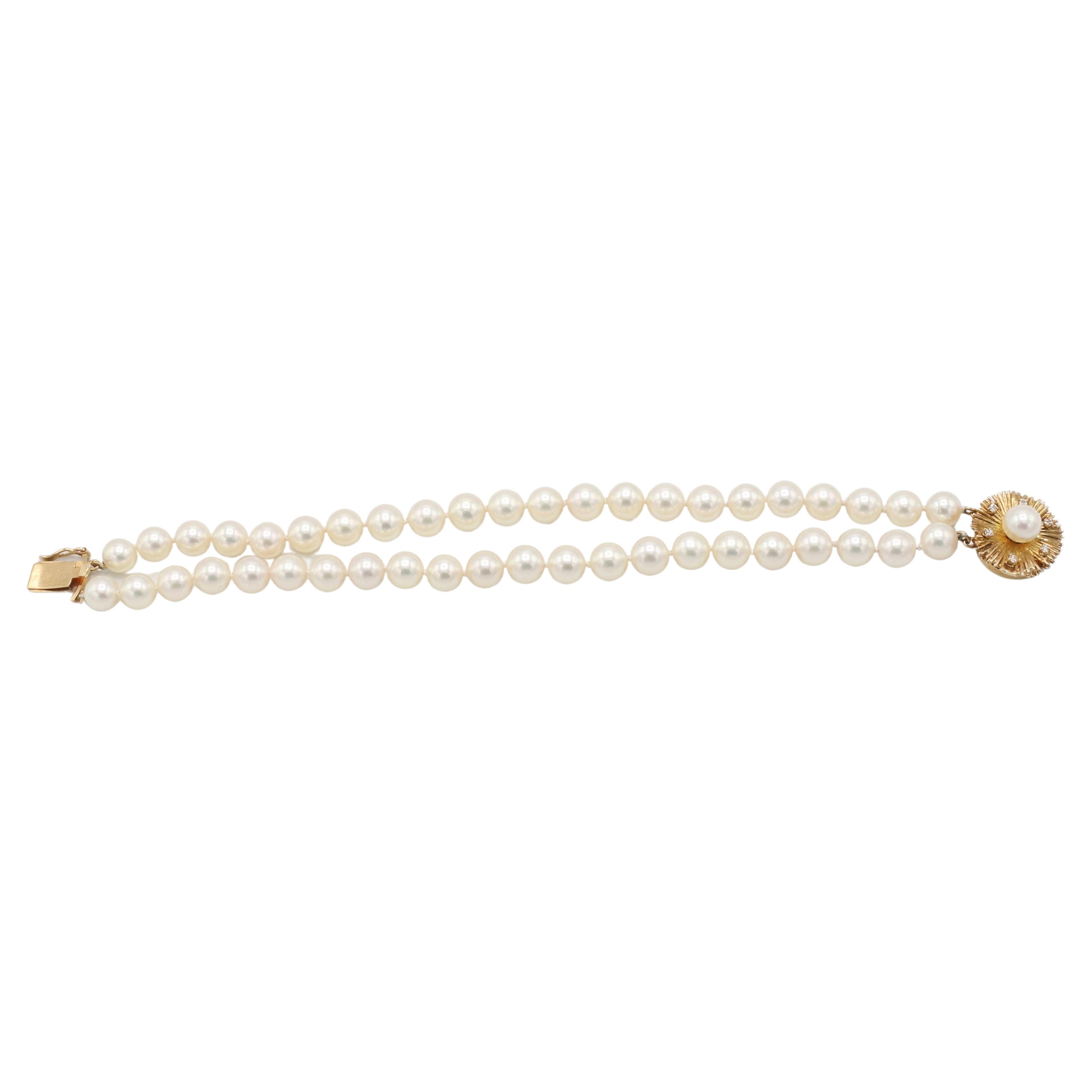 Double Strand 7mm Cultured Pearl Bracelet with Natural Diamond & Gold Clasp 
Metal: 14k yellow gold
Weight: 24 grams
Length: 7 inches
Diamonds: Approx. .06 CTW G-H VS round natural diamonds
Pearls: 7mm, 2 rows, white with creamy luster
