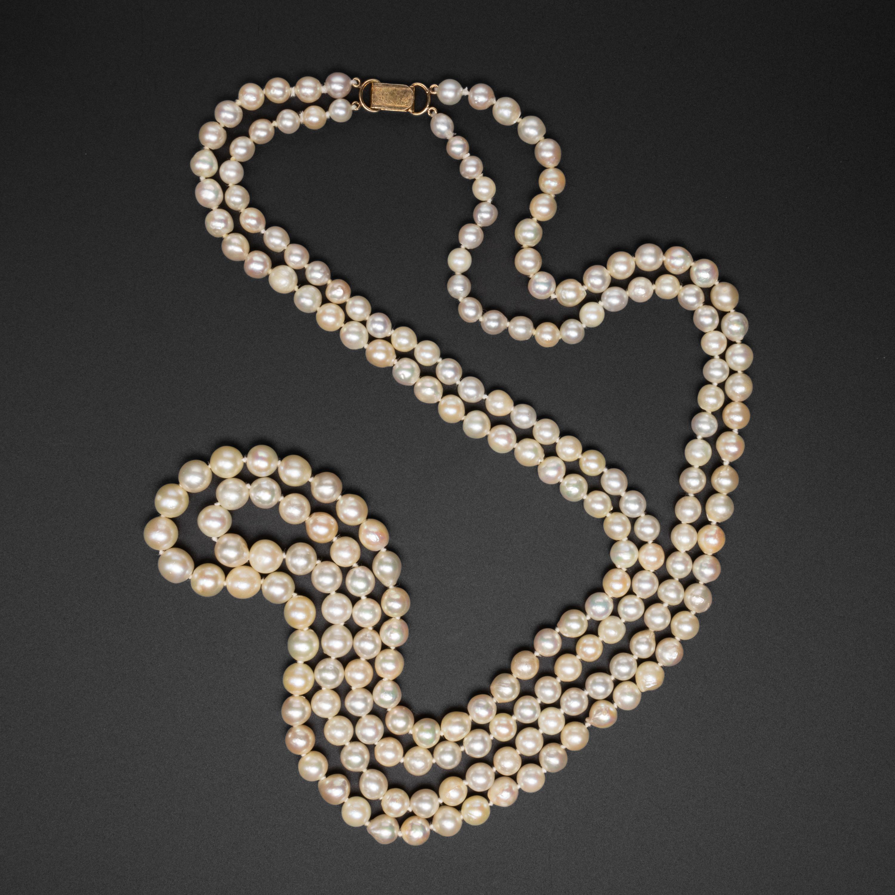 This luxurious strand of sumptuous cultured Akoya pearls from the Midcentury (circa 1960s) is composed of 206 pearls on silk, hand-knotted between each pearl. The original silk string remains in fine condition.  The pearls graduate in size from