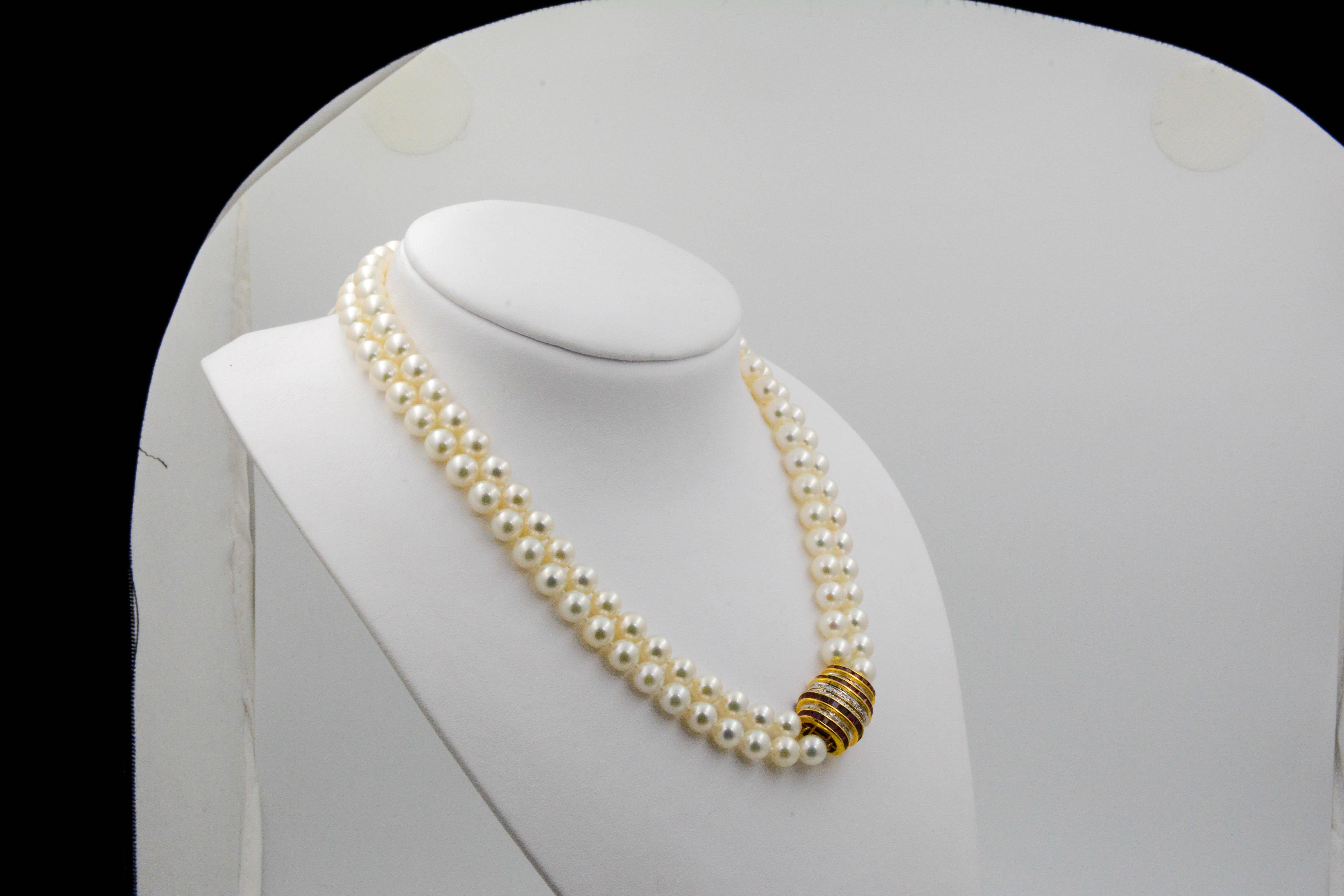 A double strand of white round Akoya pearls that measure 18 inches in length and is strung with 7.5-8 mm in diameter.  The stand is finished with a vintage 18kt yellow gold clasp set with vertical rows of round brilliant cut diamonds alternated with