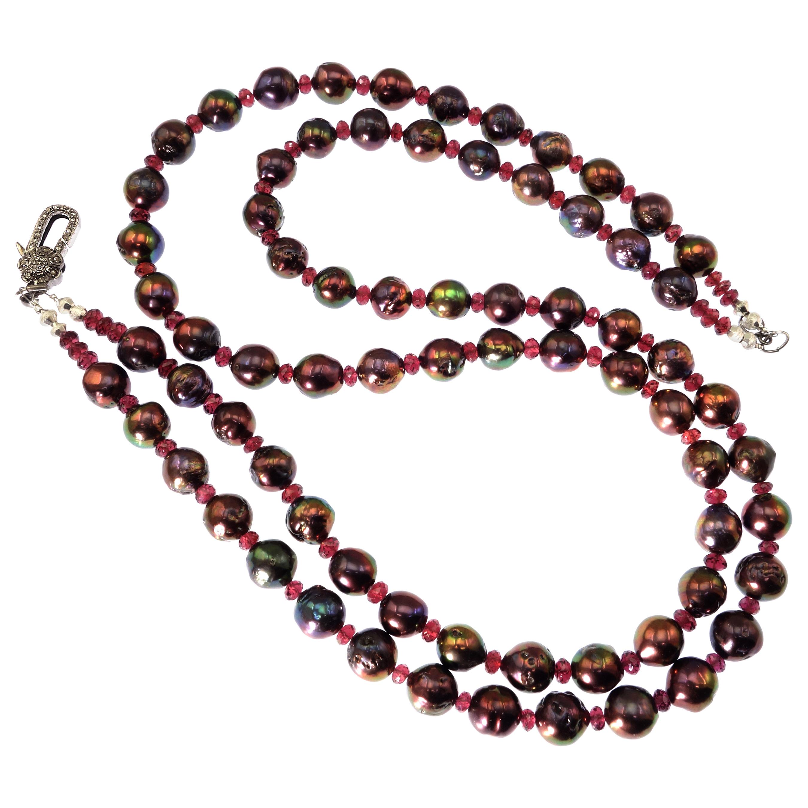 'Put on your Pearls Girls' Lulu Guinness

Custom made Double strand necklace of 10MM Aubergine Pearls enhanced with faceted Rhodolite rondelles. These gorgeous Pearls have lovely flashes of orange and green. These unique Pearls are a bit off round