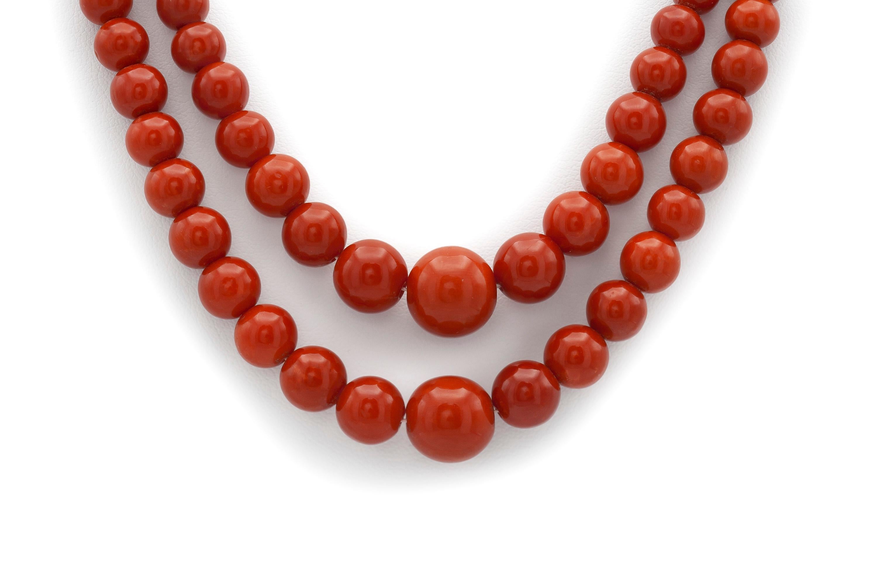 Finely crafted in 18K yellow gold with vivid red coral beads.
The coral beads range from 12.27 - 5.10mm.
The shorter strand measures 20 1/4 inches in length, and the longer strand measures 21 1/2 inches.