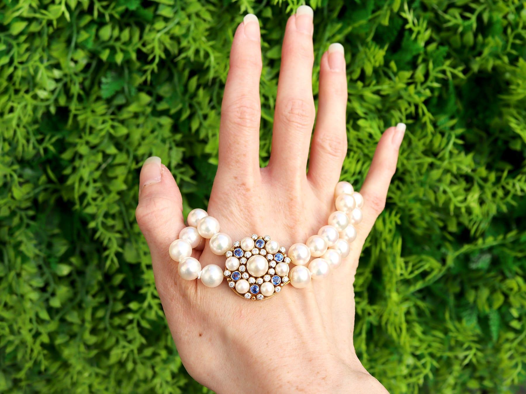A fine and impressive vintage double strand pearl necklace with a 1.92 carat sapphire and 1.06 carat diamond 18 karat yellow gold clasp; part of our diverse pearl jewelry collection.

This fine and impressive vintage pearl necklace displays two