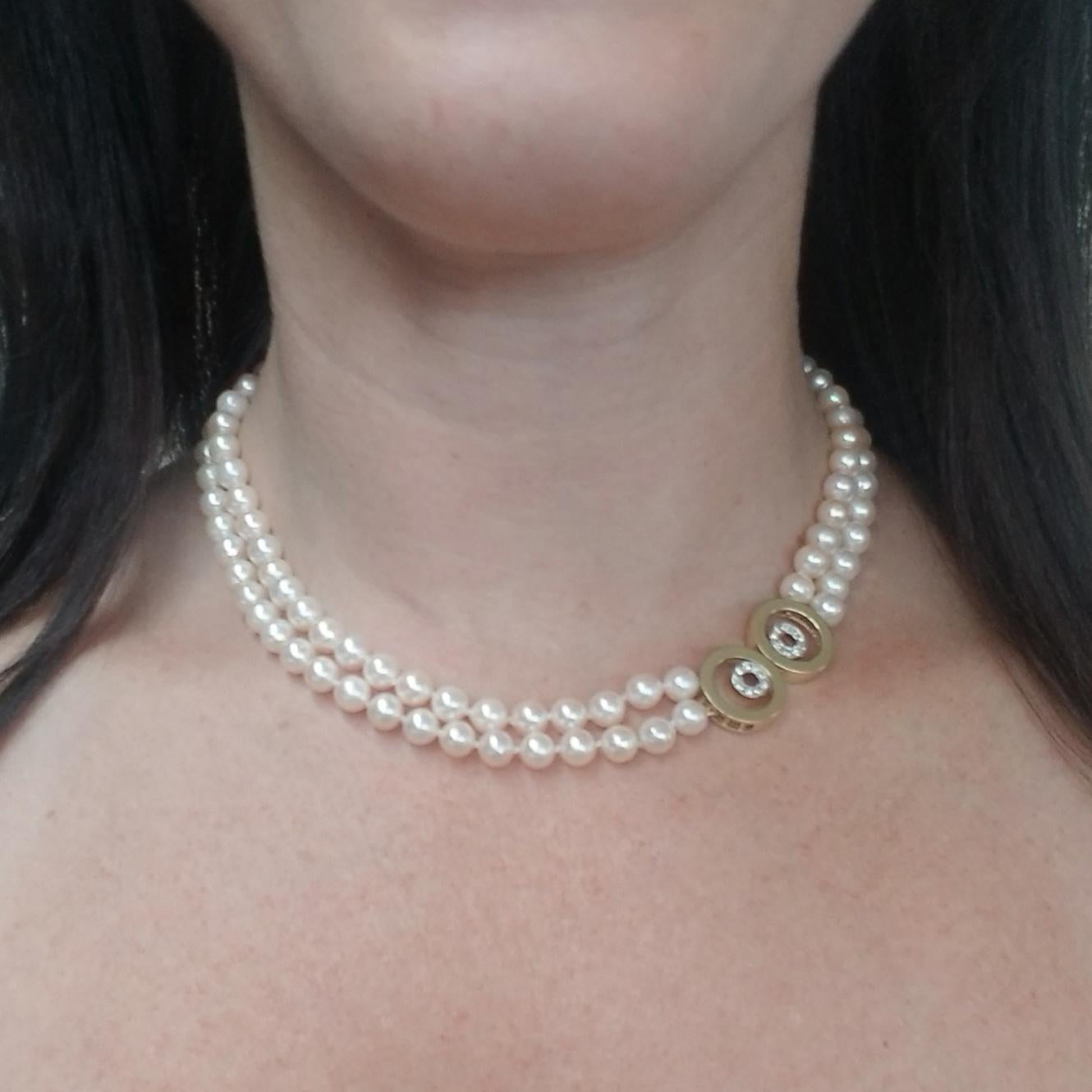 14 Karat Yellow Gold Double Pearl Strand Collar Necklace Featuring 107 Round Cultured Pearls Measuring 6mm-6.5mm. Decorative Hidden Clasp Contains 18 Round Diamonds Totaling Approximately 0.18 Carats of VS Clarity & G Color. 16 Inches Long. Recently
