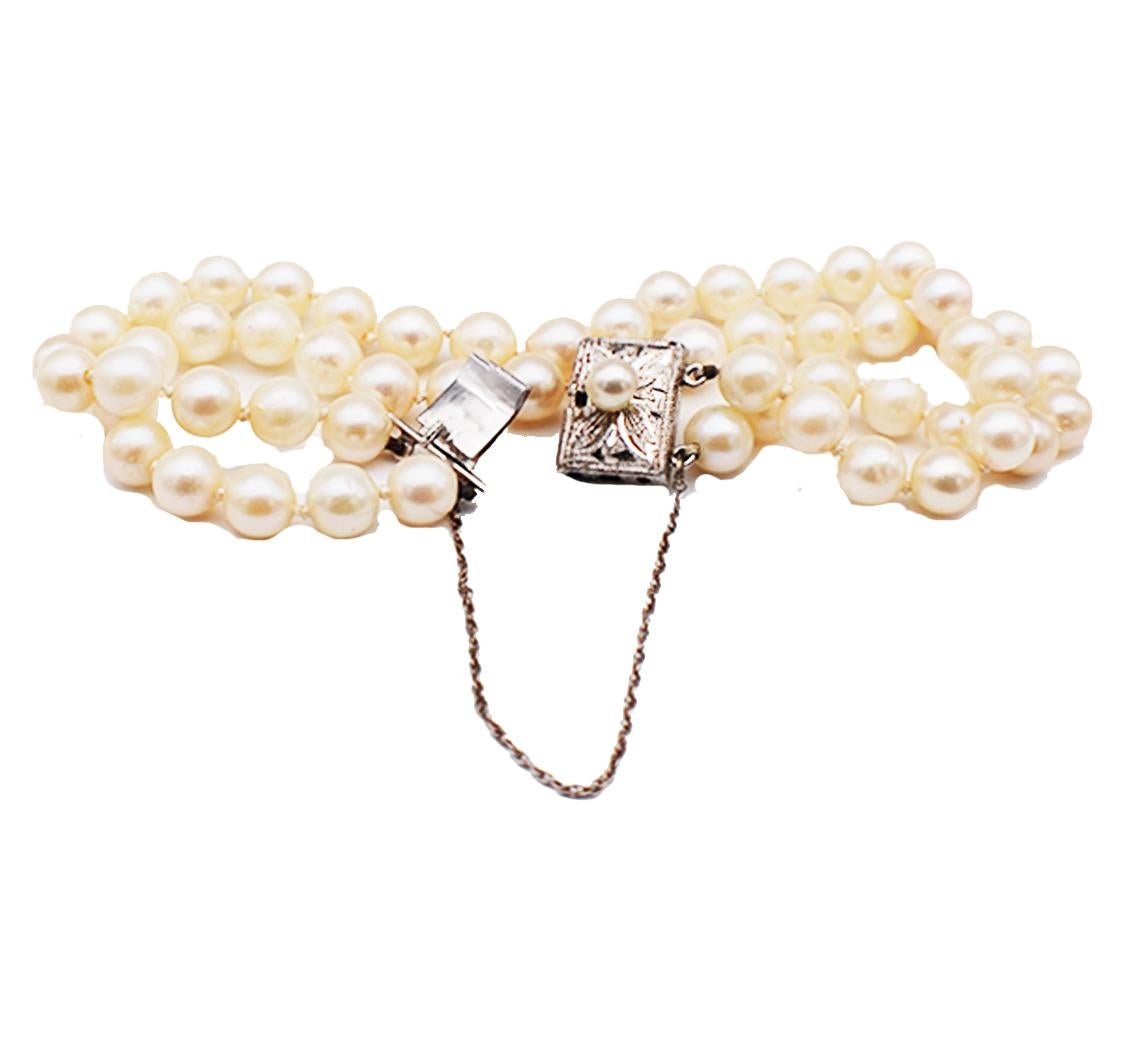 Double strand vintage pearl bracelet, Circa 1950's are 6mm strung and suspended with a silver clasp. The pearls are evenly match and consist of 56 nearly unblemished quality.  The pearls color are a creamy white with luster which are knotted