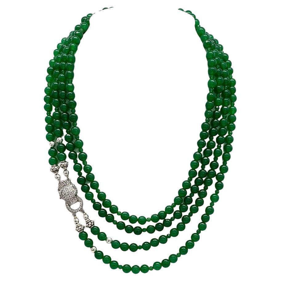 Si tratta di una collana di giada in stile Art Déco con chiusura a leopardo in argento sterling. Abbiamo creato questa collana a doppio filo con fili lisci da 6 mm e sfaccettati da 3 mm.  perline di giada verde naturale. Questa collana è