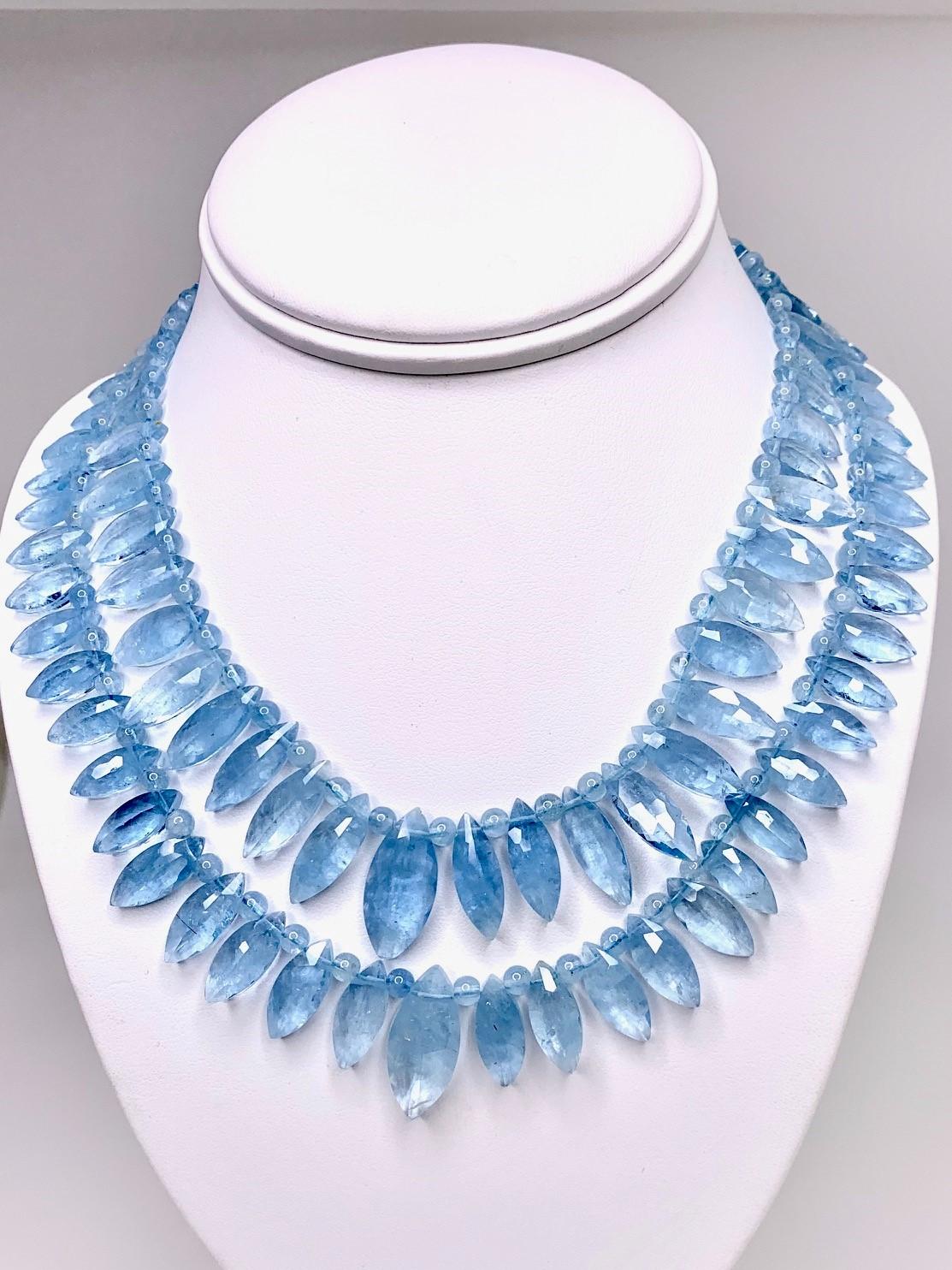 This striking necklace features two strands of beautiful Brazilian aquamarine beads in graduating marquise shapes, separated by round aquamarine beads. The beads are a mesmerizing shade of aqua blue and the 2-inch extender offers wonderful
