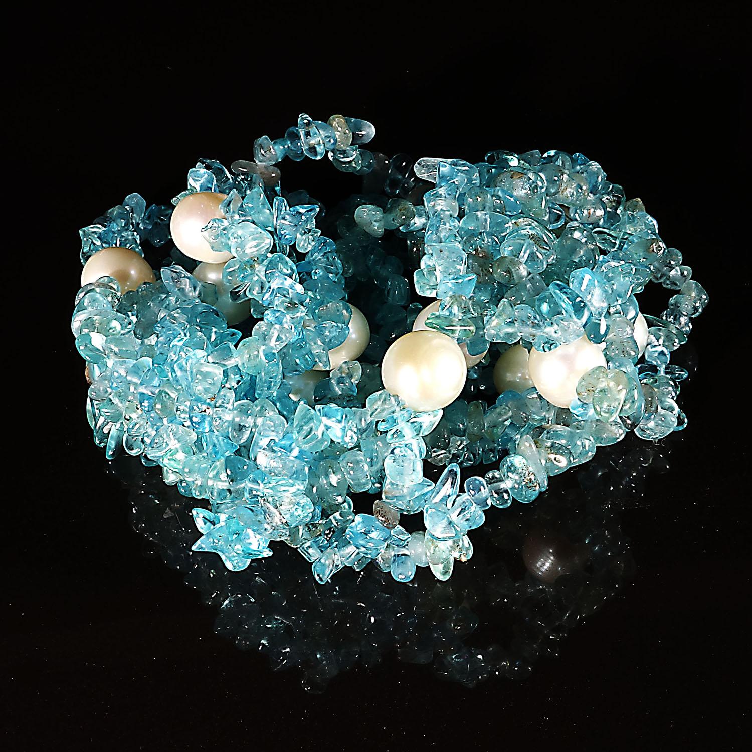 Custom made infinity necklace of sections of double strands of glittering neon blue Apatite chips secured with white Freshwater Pearls. These highly polished Apatite chips almost glow they are so bright. This unique necklace is 38 inches in length