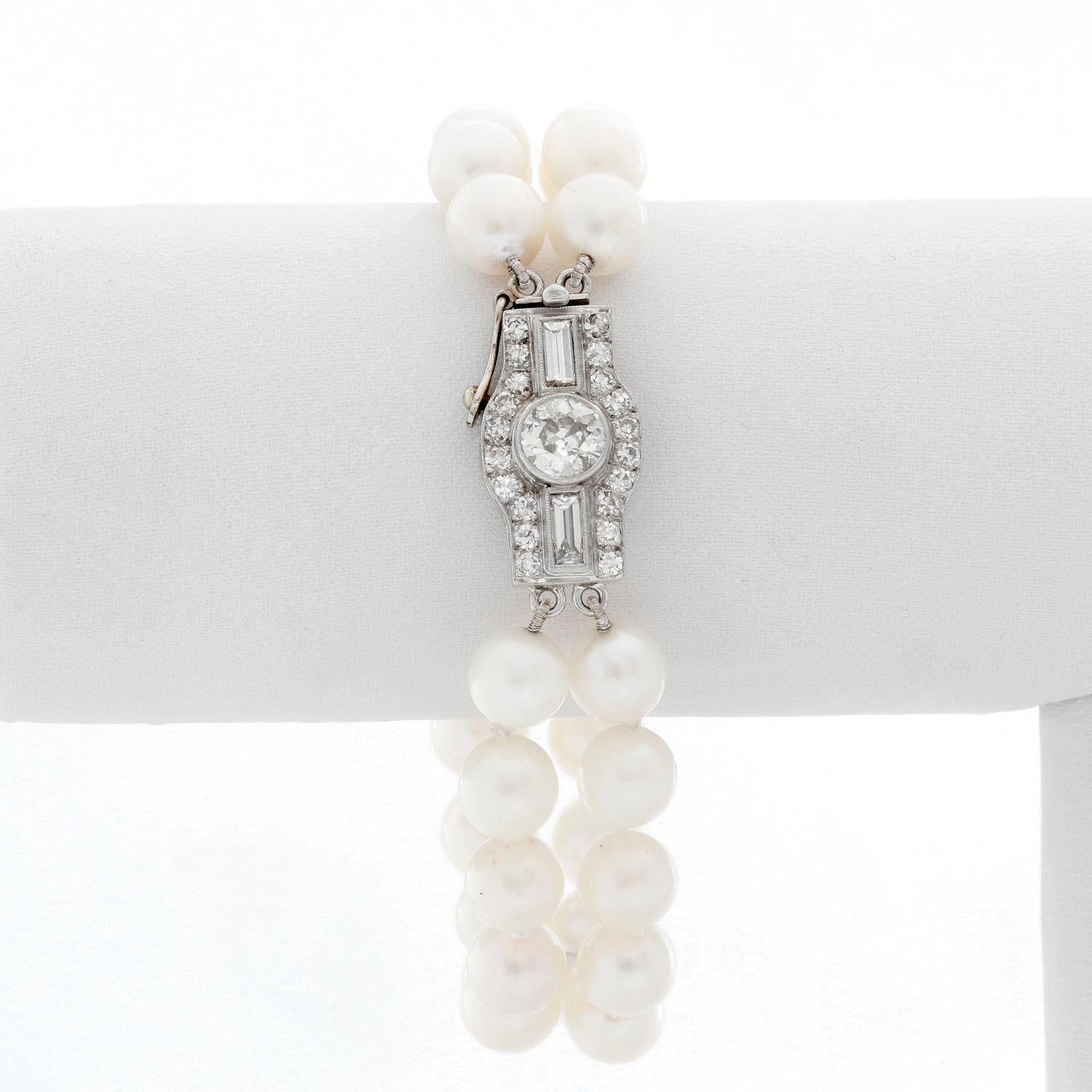 Double Strand Pearl Bracelet With Diamonds - Art deco style bracelet with 2 strands of pearls and an oversized diamond clasp. Bracelet measures approx. 6 1/2 inches with approx. 1 ct of diamonds. Pre-Owned .