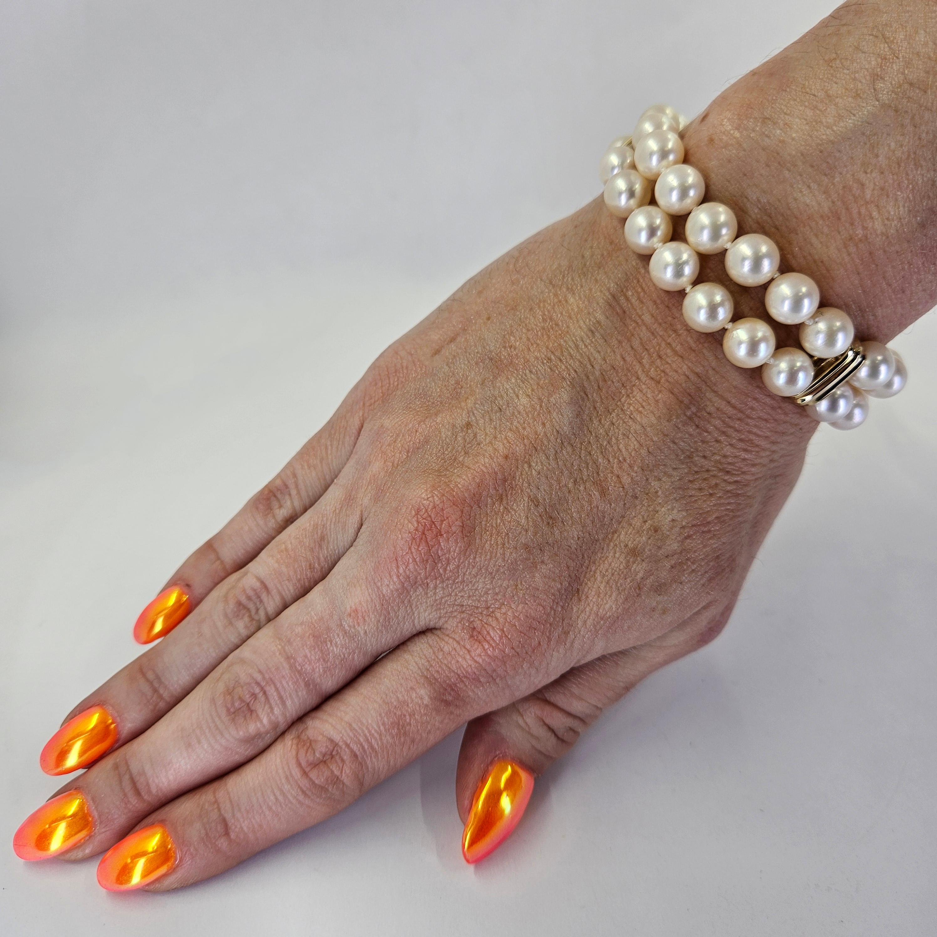 14 Karat Yellow Gold Double Strand Pearl Bracelet Featuring 38 Cultured 8mm Round Pearls with Hidden Clasp and Figure 8 Safety. 7 Inches Long. Finished Weight is 30.7 Grams.