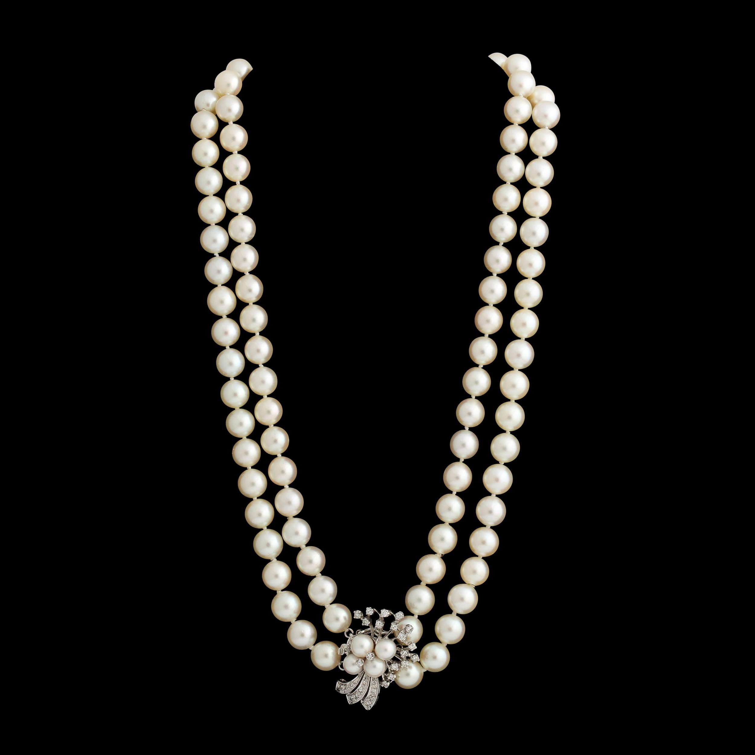 This double strand Pearl necklace is set with is set with a diamond and cultured pearl clasp in 14k white gold set  with single cut diamonds .The cultured pearls are approximately 8 mm each and have a lovely cream body color and good luster with
