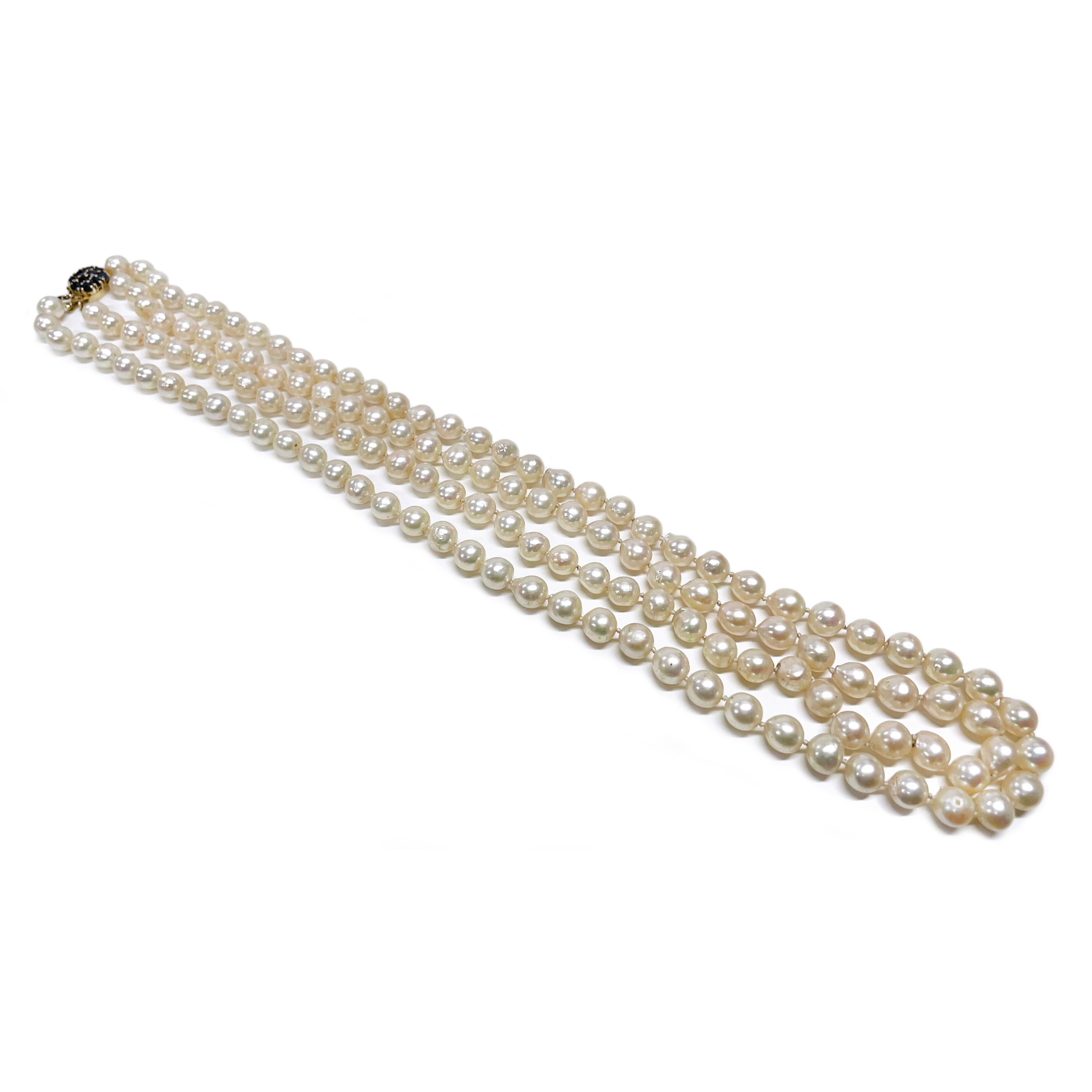 14 Karat Yellow Gold Double Strand Baroque Pearl Sapphire Necklace. This beautiful necklace features double strands of lovely semi-Baroque pearls ranging in size from 7 - 7.5mm. The one-hundred thirty-two pearls are creamy in color with a slight