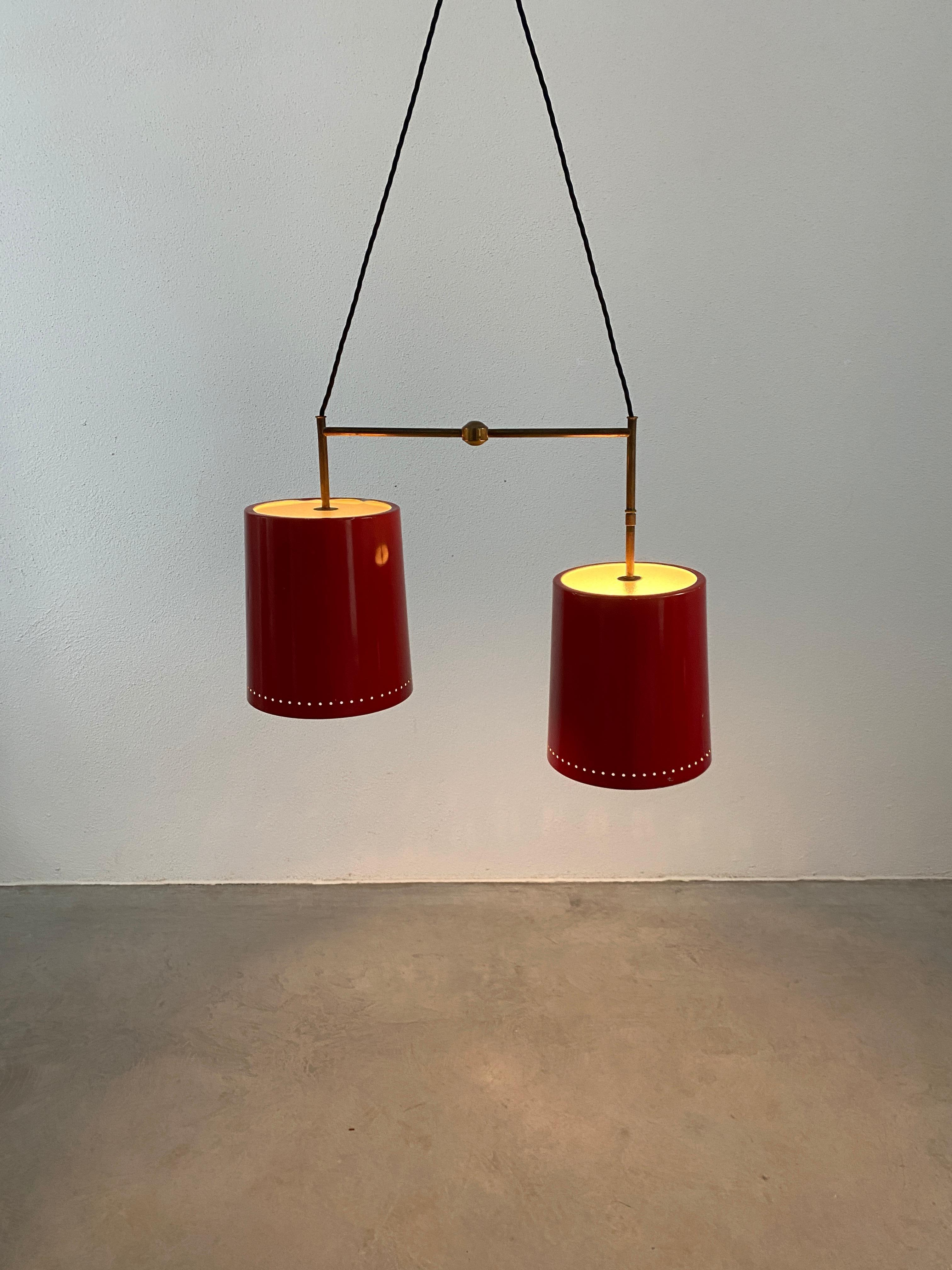 Rare double suspension chandelier Stilnovo, Italy, 1950

Two-cord suspension light with original canopy. Two red lacquered aluminum slightly conical tubes with glass disks. The fixture is in original condition with no damages to the glass, fully