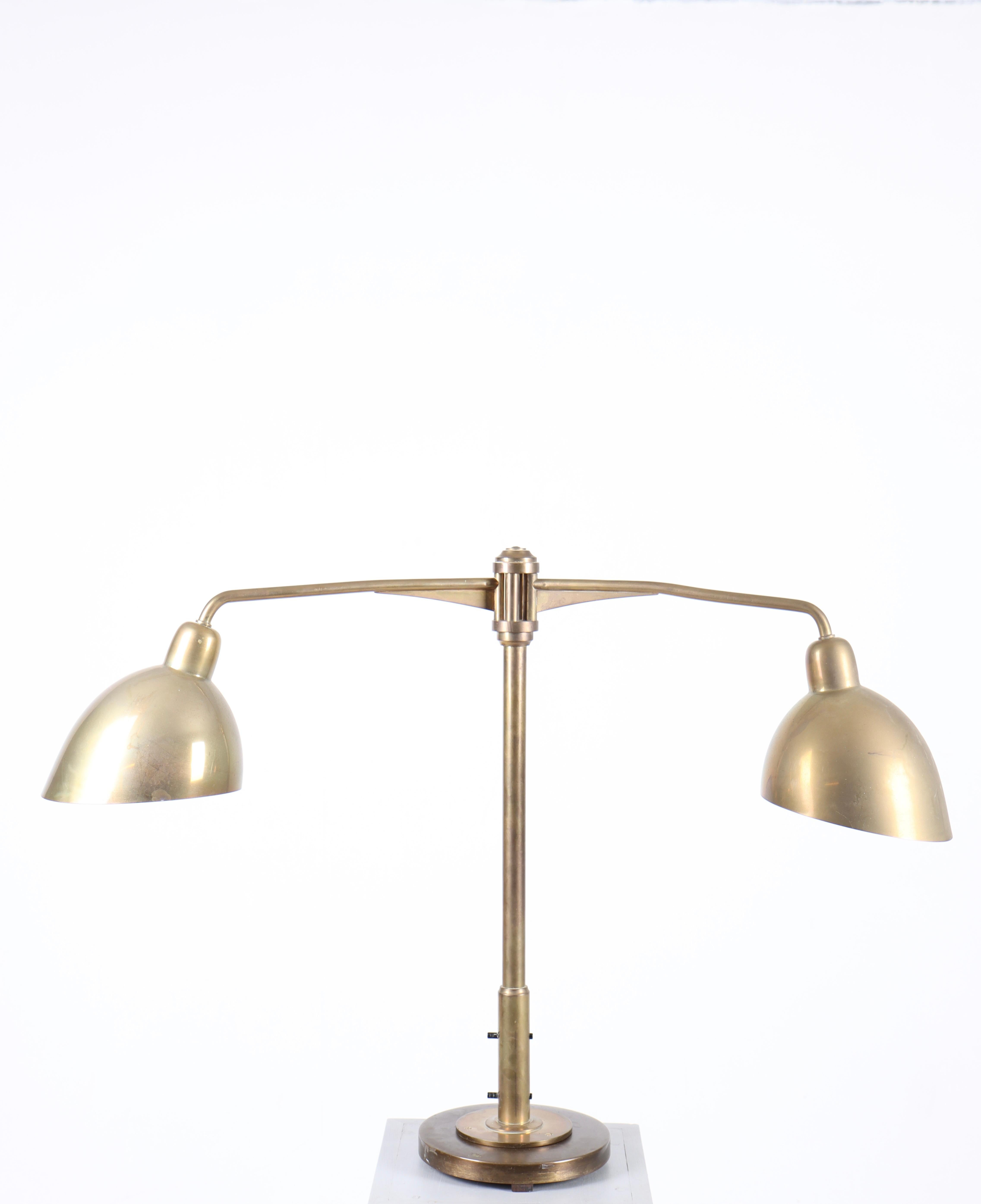 Decorative table lamp in brass designed and made by Louis Poulsen. Great original condition.