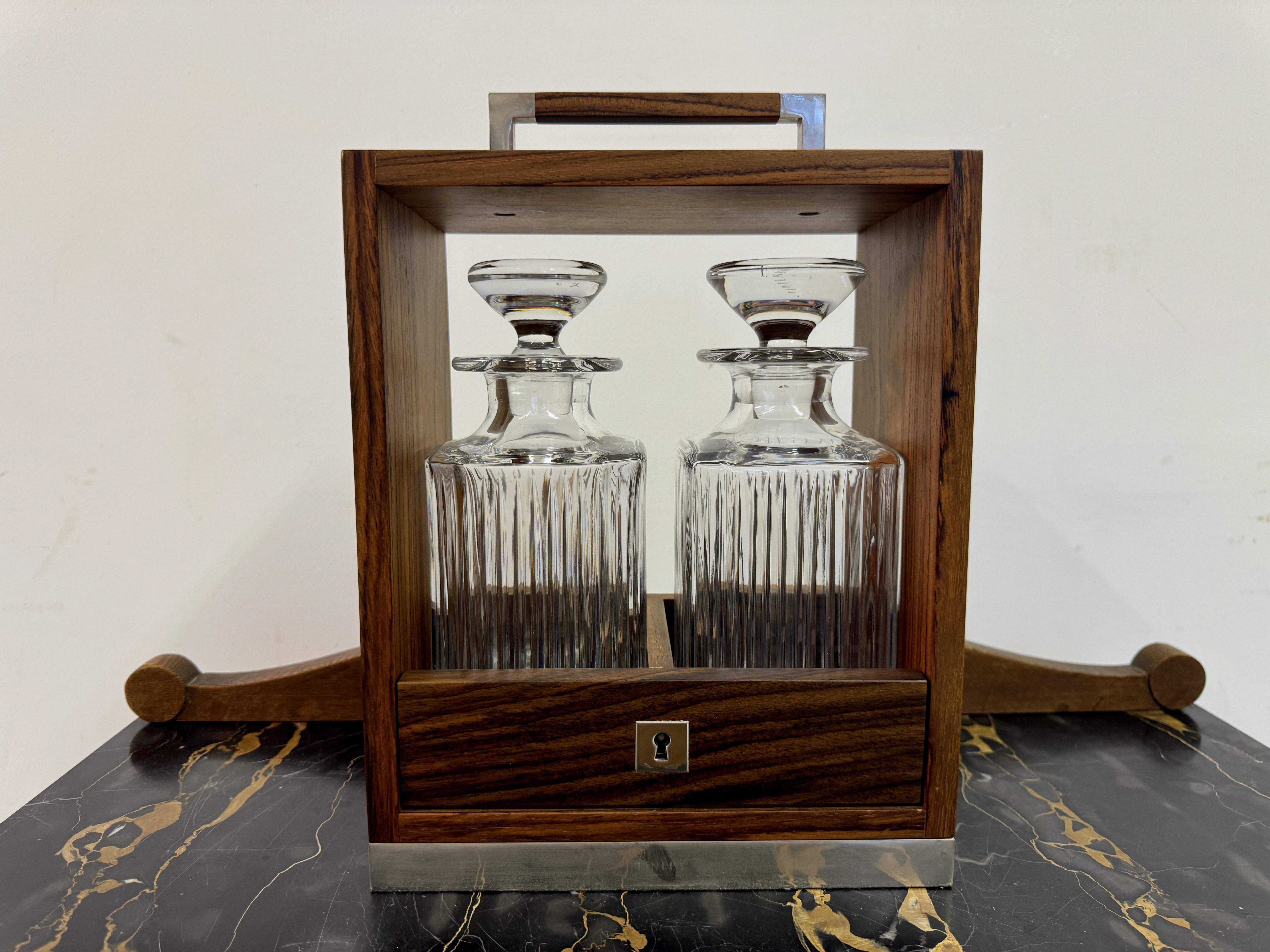 Double Tantalus

By Linley

Walnut Frame

Matching lead crystal decanters marked Linley on top

Silver escutcheon plate with hall marks

No key

This beautifully crafted tantalus by Linley exemplifies the brand's dedication to exceptional