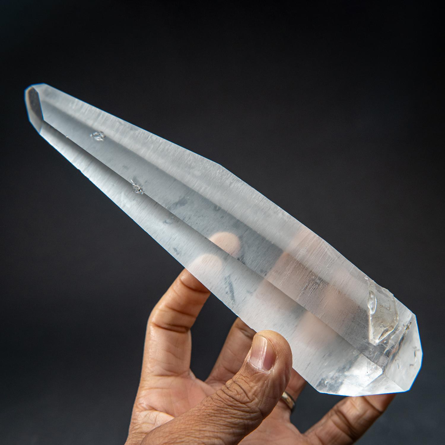 This museum-quality Brazilian Lemurian Quartz Crystal is a remarkable double terminated floater single crystal. Water clear and perfectly terminated on both ends, this crystal is all natural and unpolished. Unparalleled in its power, Lemurian Quartz