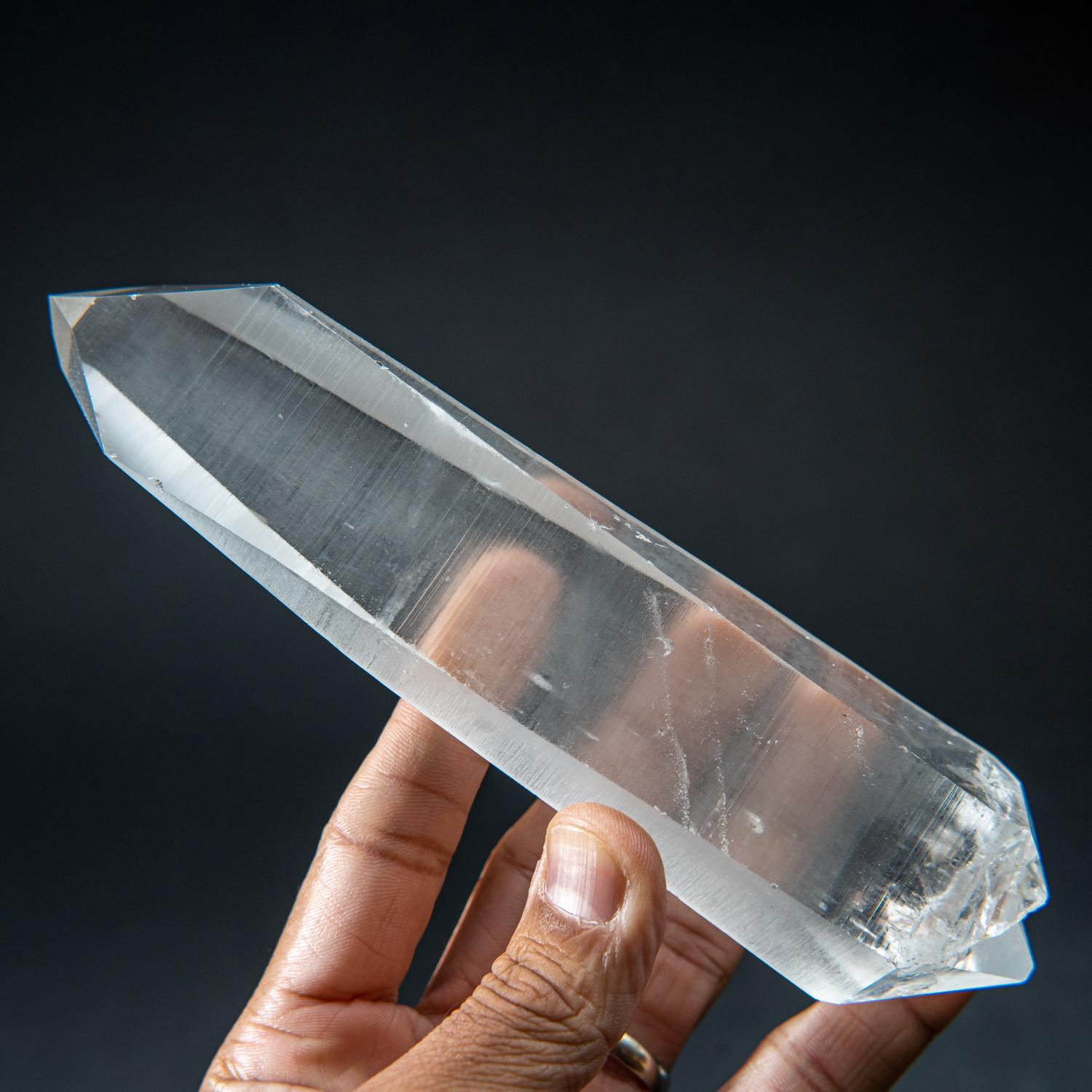This museum-quality Brazilian Lemurian Quartz Crystal is a remarkable double terminated floater single crystal. Water clear and perfectly terminated on both ends, this crystal is all natural and unpolished. Unparalleled in its power, Lemurian Quartz