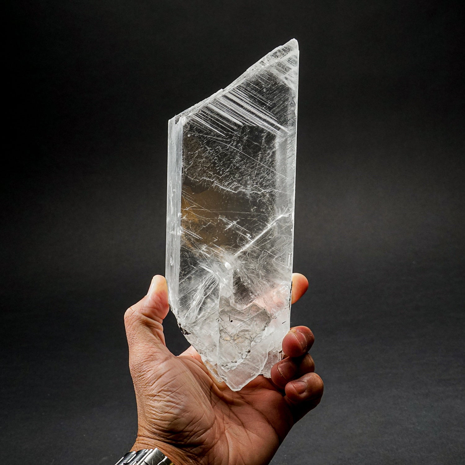 Large optical, water-clear crystal of selenite with clean, lustrous surfaces. The crystal is doubly terminated, with sugary white micro crystals coating one termination. It has an impressive structure and symmetry fashioned by the Earth, making it