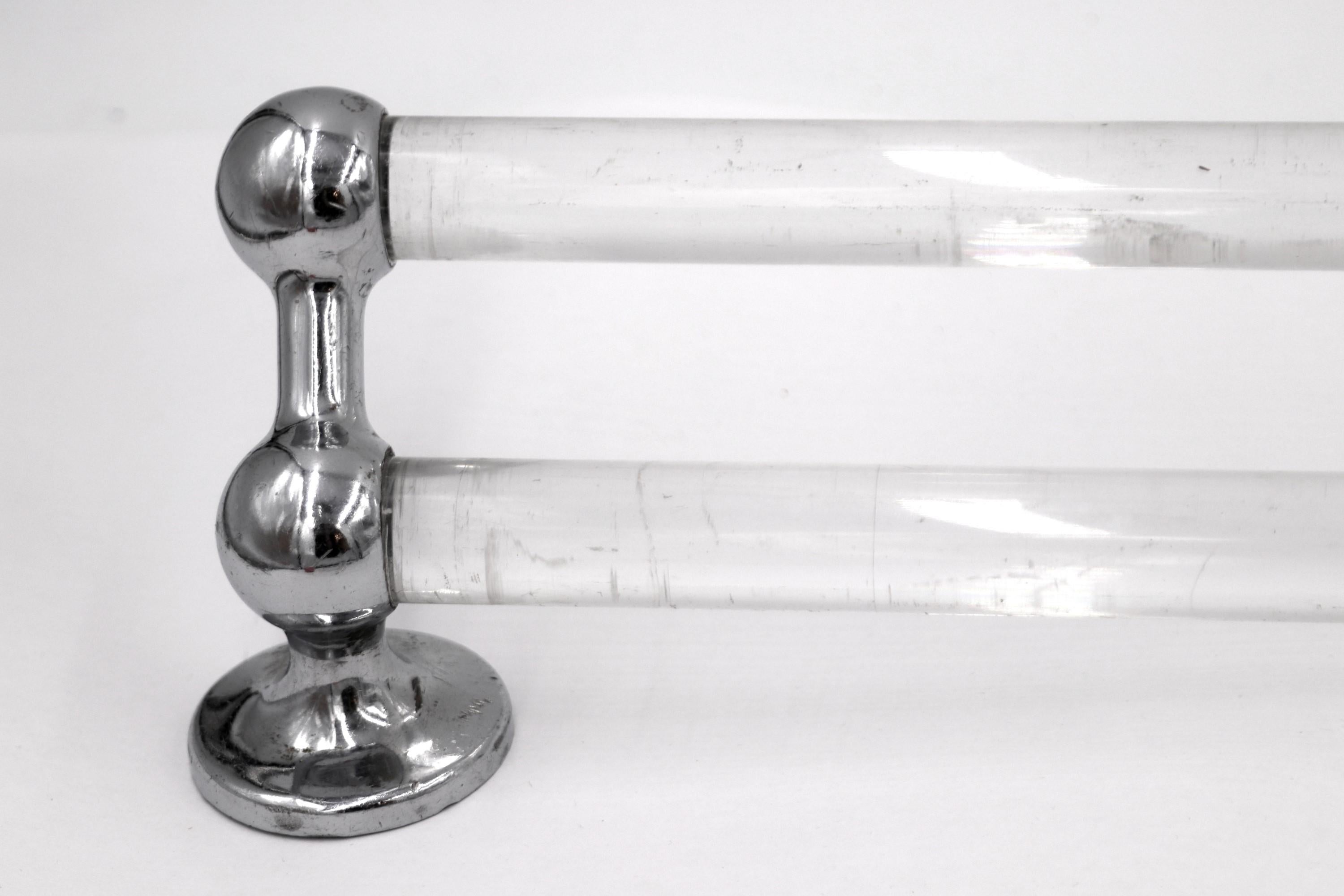 Vintage double Lucite towel bar rack with original chrome plated brass brackets. Due to its age, there is some wear. Measure - 26 in.
 