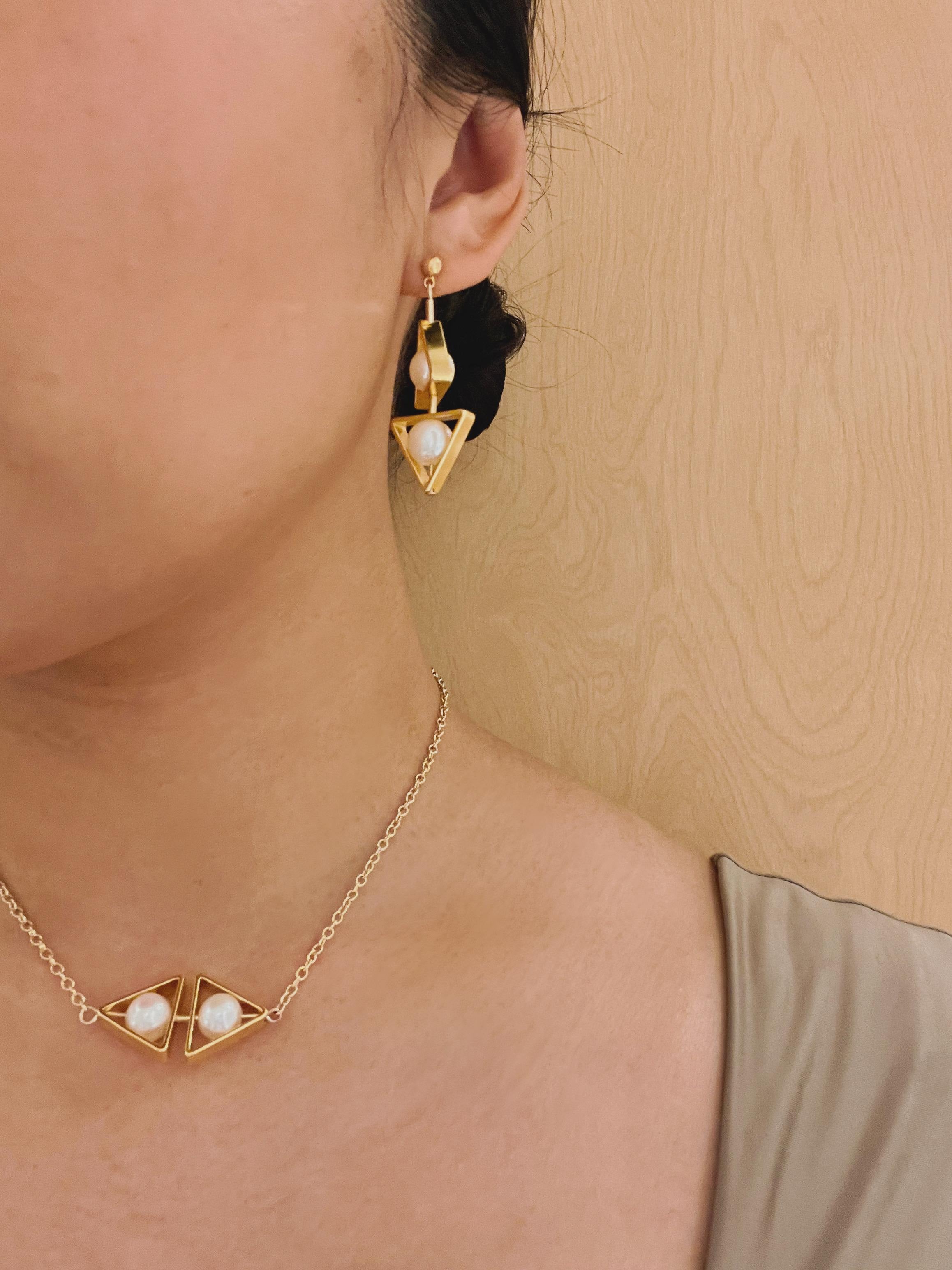 The earrings are light weight and are made to rotate and reposition with movement.

The earrings consist of triangle freshwater pearls, gold filled findings and gold-plated brass metal shapes.

Due to the nature of this jewelry, it is