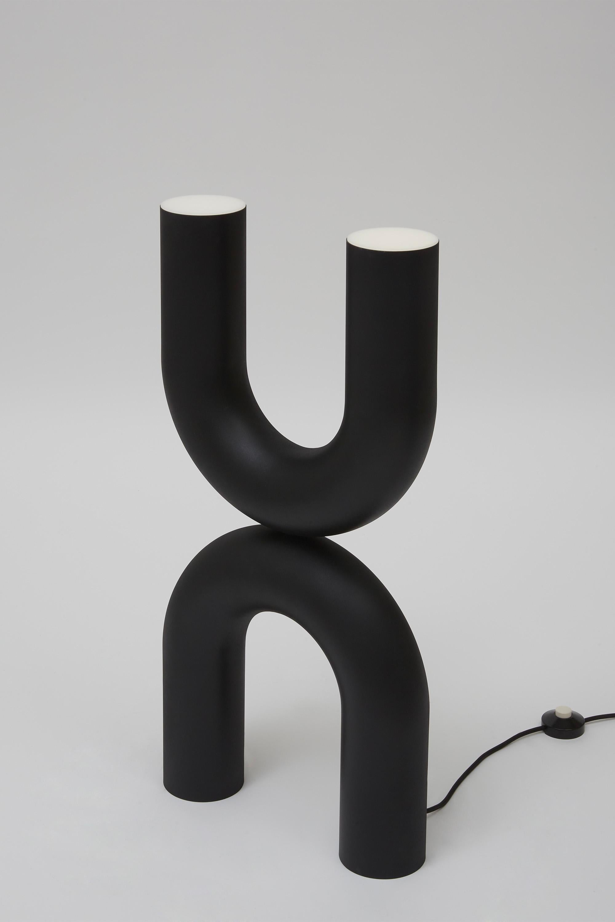 A totemic design obtained by piling two Us facing opposite directions, this stunning floor lamp will provide illumination while adding an exquisite artistic twist to corners of contemporary homes. The steel frame features a homogeneous black finish