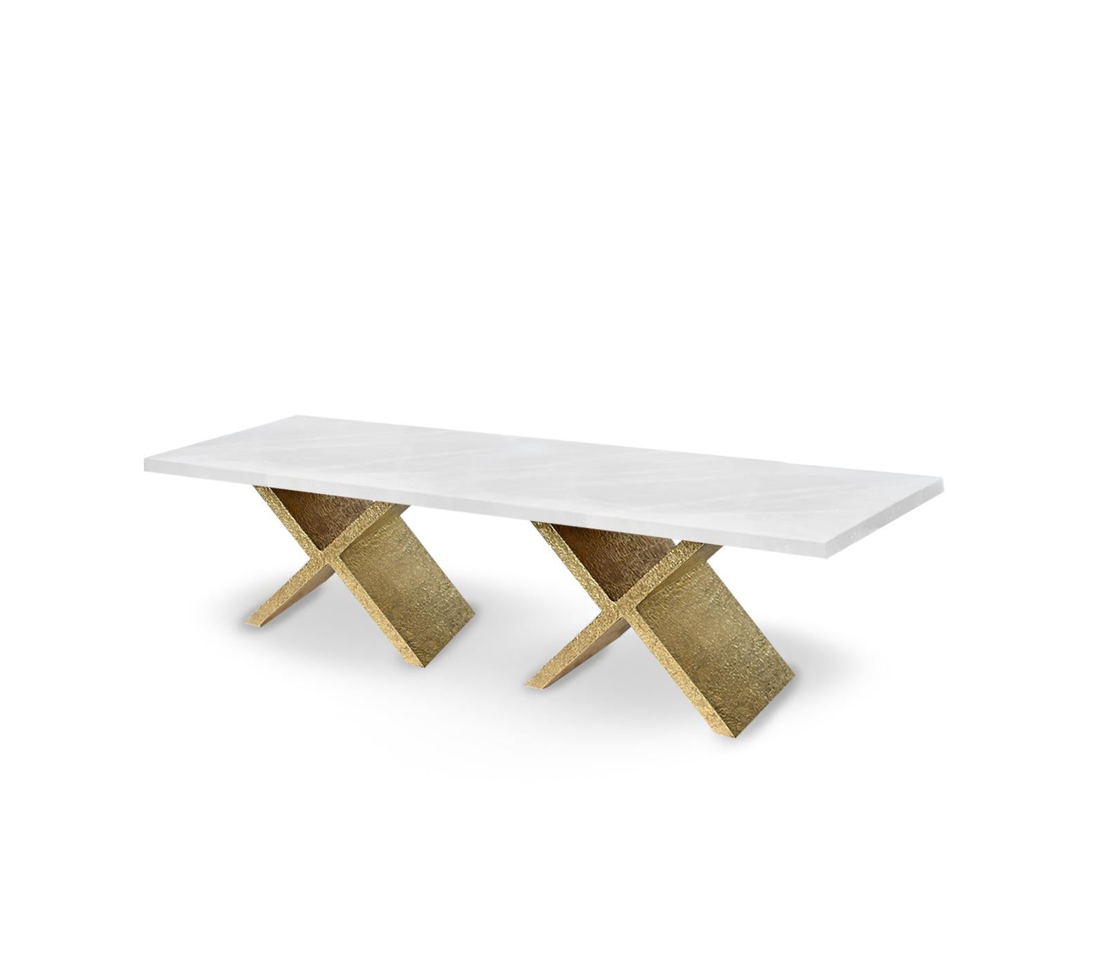 X coffee table, hammered details X brass bases with rock crystal top. Created by Phoenix gallery.

 