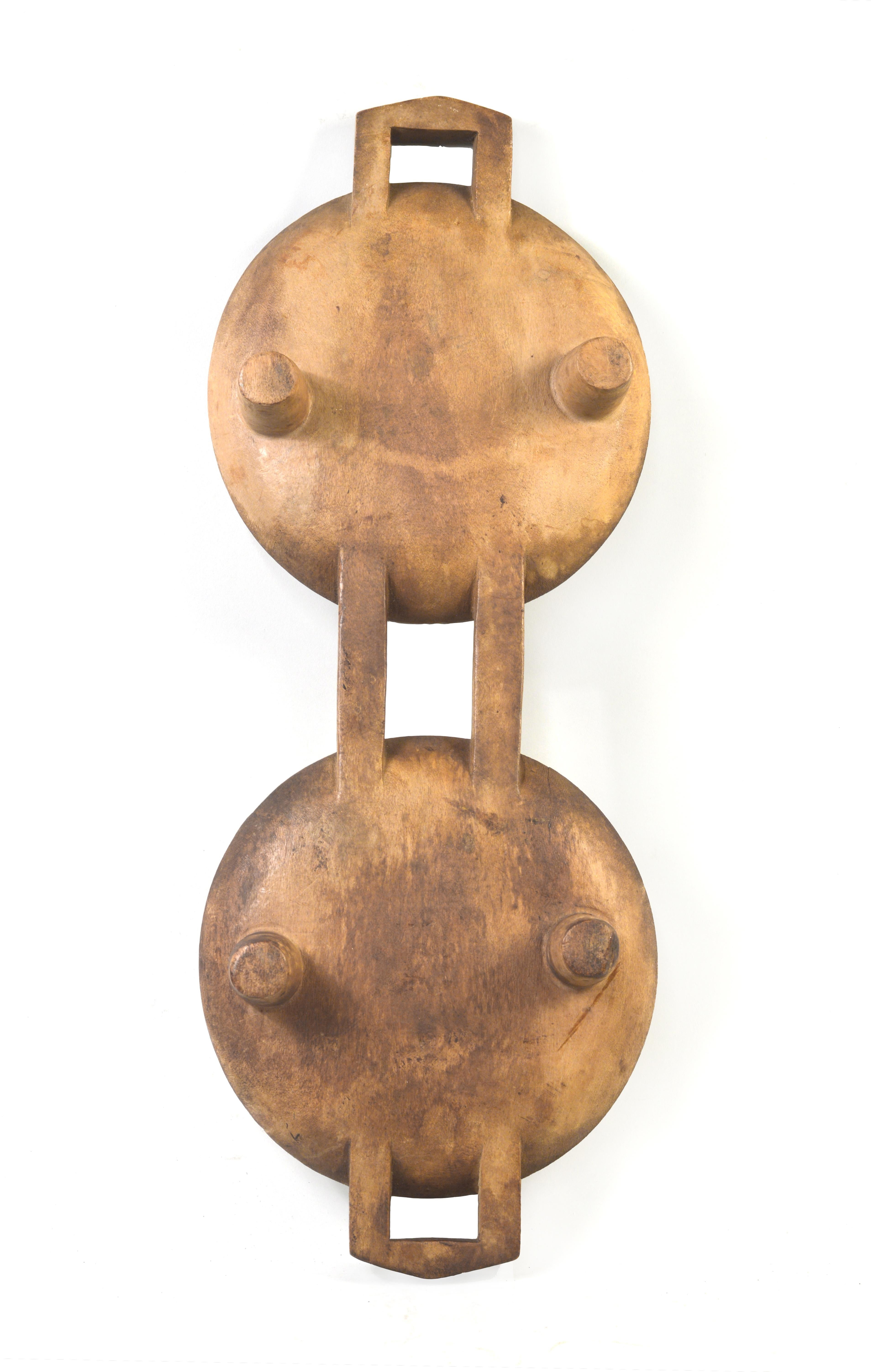 Zulu meat platters, called ugqoko in Zulu, are used at ceremonial gatherings for the carving and serving of meat from ritually-slaughtered livestock. The distinctive double platter form of this ugqoko serves as a mnemonic device that helps