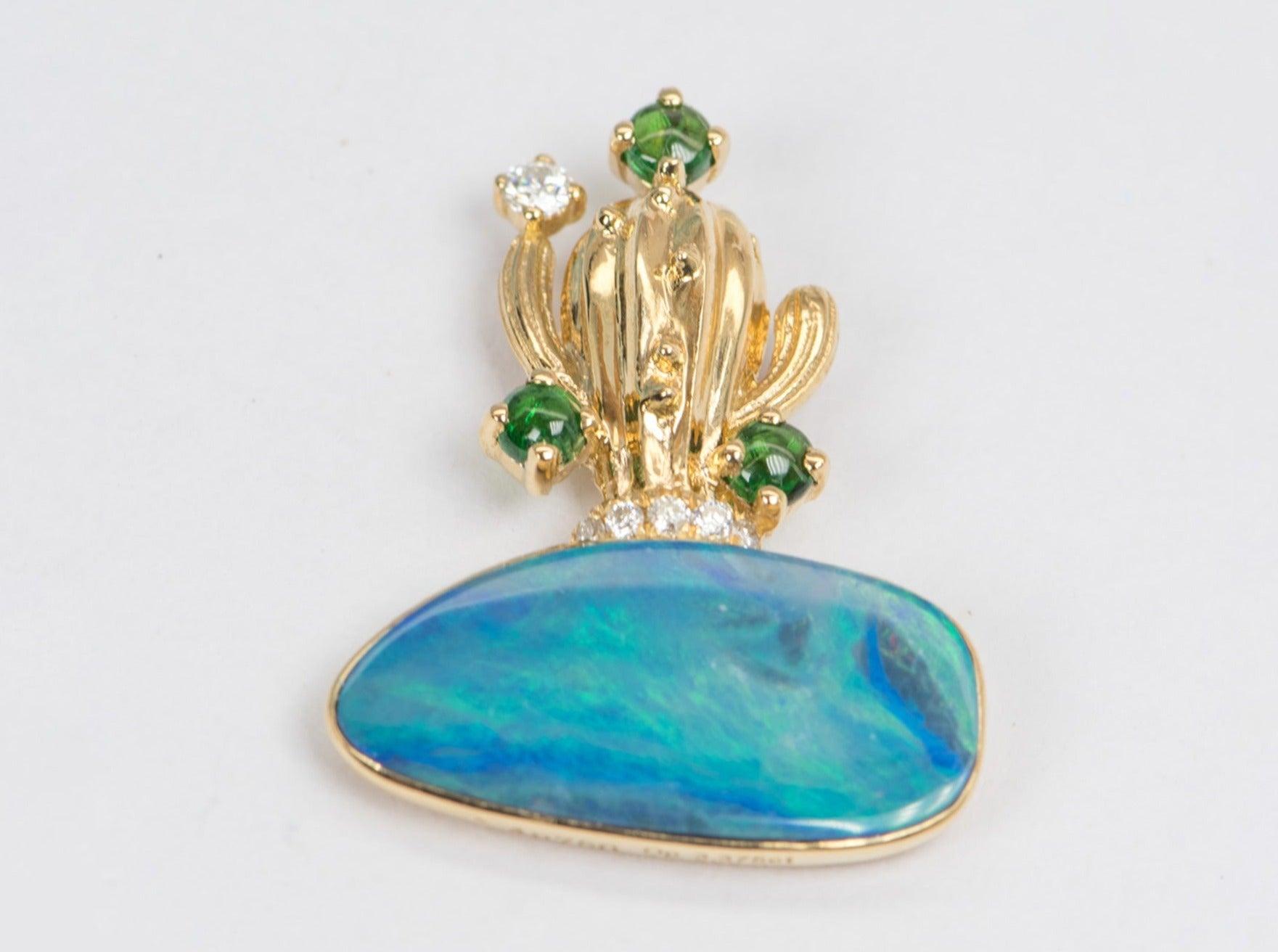 ♥ Solid 18k yellow gold cactus pendant set with a beautiful doublet Australian Opal, moissanites, and tsavorites
♥ Gorgeous blue color!
♥ The item measures 24.7 mm in length, 19.1 mm in width, and is 5.6 mm thick

♥ Gemstone: Opal, 3.37t;