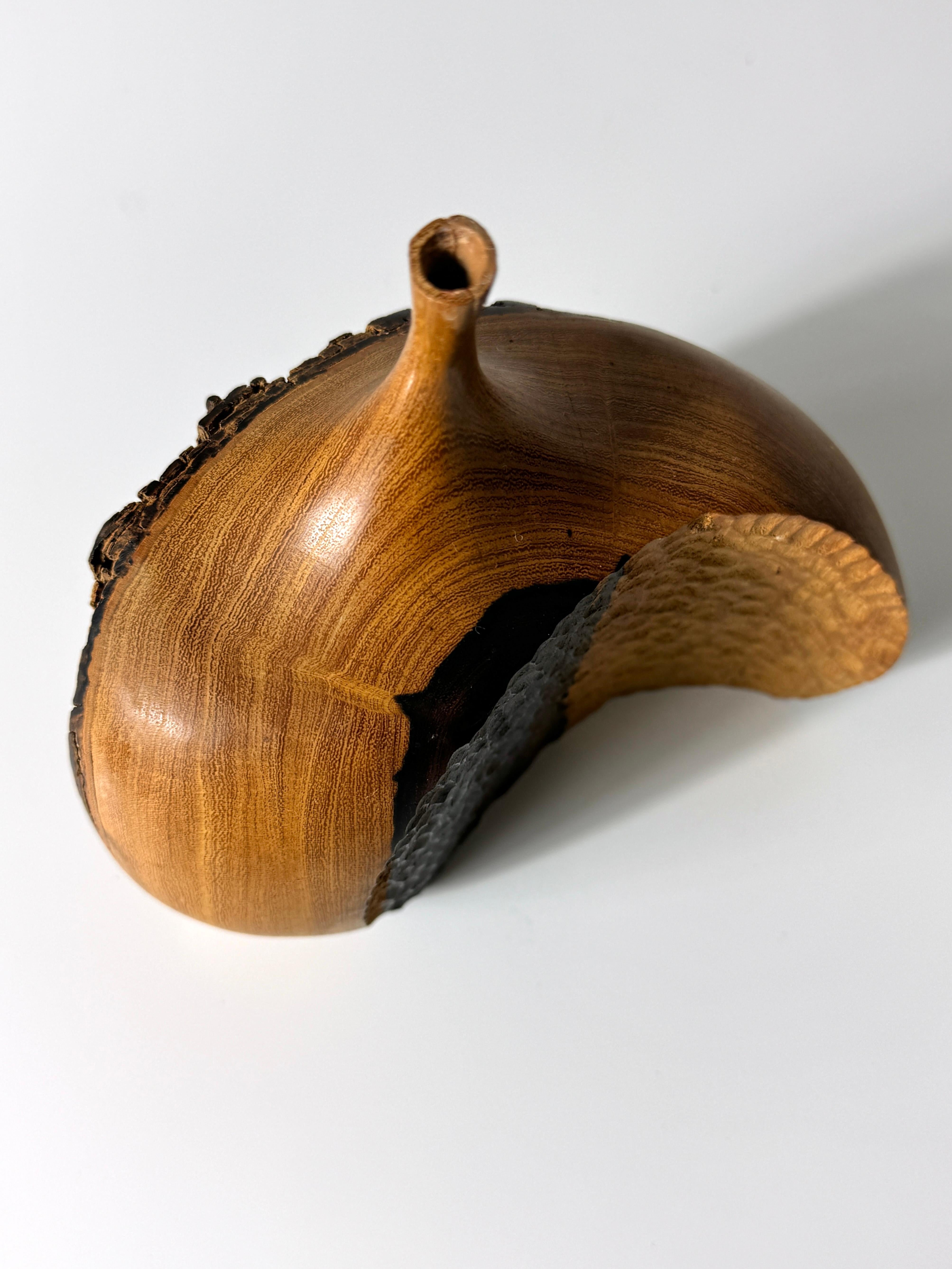 Modernist vessel or weedpot by California crafstman Doug Ayers 1979
Executed in Desert Ironwood with in-curved chip carving opposite a live edge 
Signed to underside with original labeling

6 inch width
3 inch depth
6 inch height