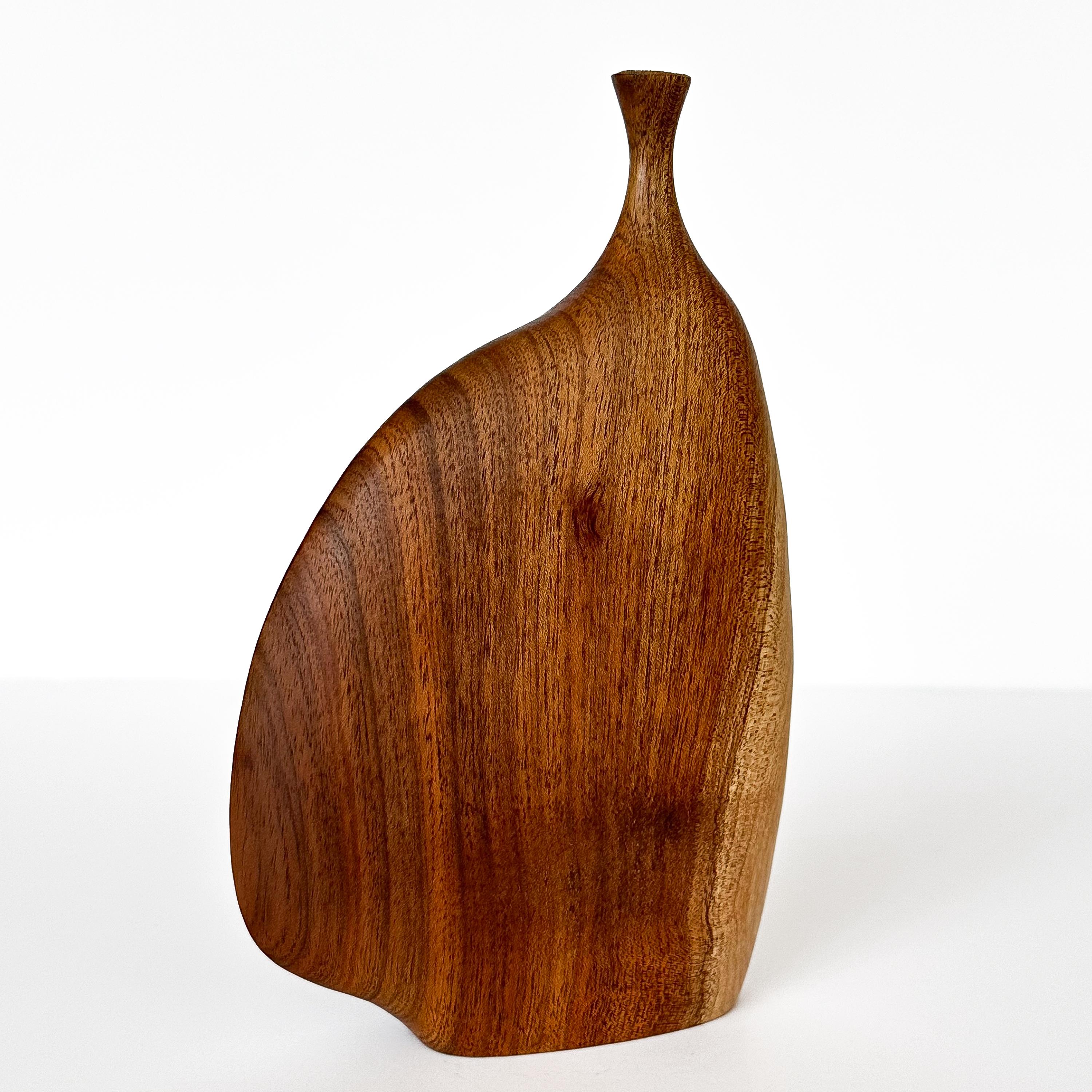 Introducing an extraordinary sculpted wood-turned weed vase by the acclaimed American/California-based artist, Doug Ayers, circa 1970s.  This weed vase is an exquisite example of Ayers' masterful craftsmanship. Thought to be possibly walnut, the