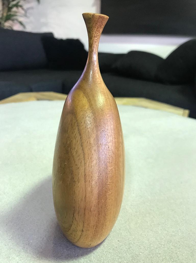 A very beautifully made and sculpted wood turned weed vase by famed American (Mendocino, CA) artist/ sculptor Doug Ayers. 

Signed by Ayers on the base.

Ayers work is becoming hard to find. He died tragically young. This piece is made of red