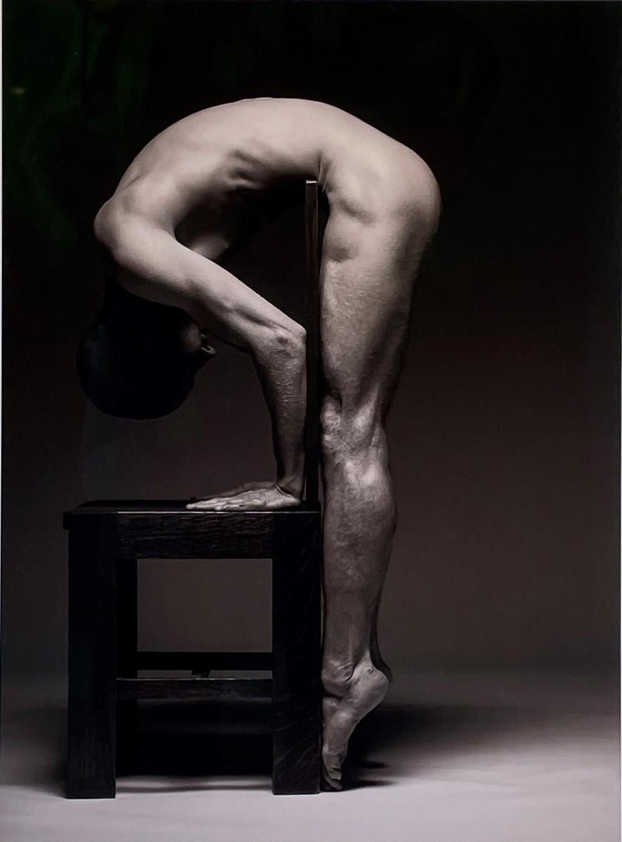 Doug Birkenheuer Nude Photograph - Centerfold - Muscular Male Nude Bent Over Wooden Chair, Black & White Photograph