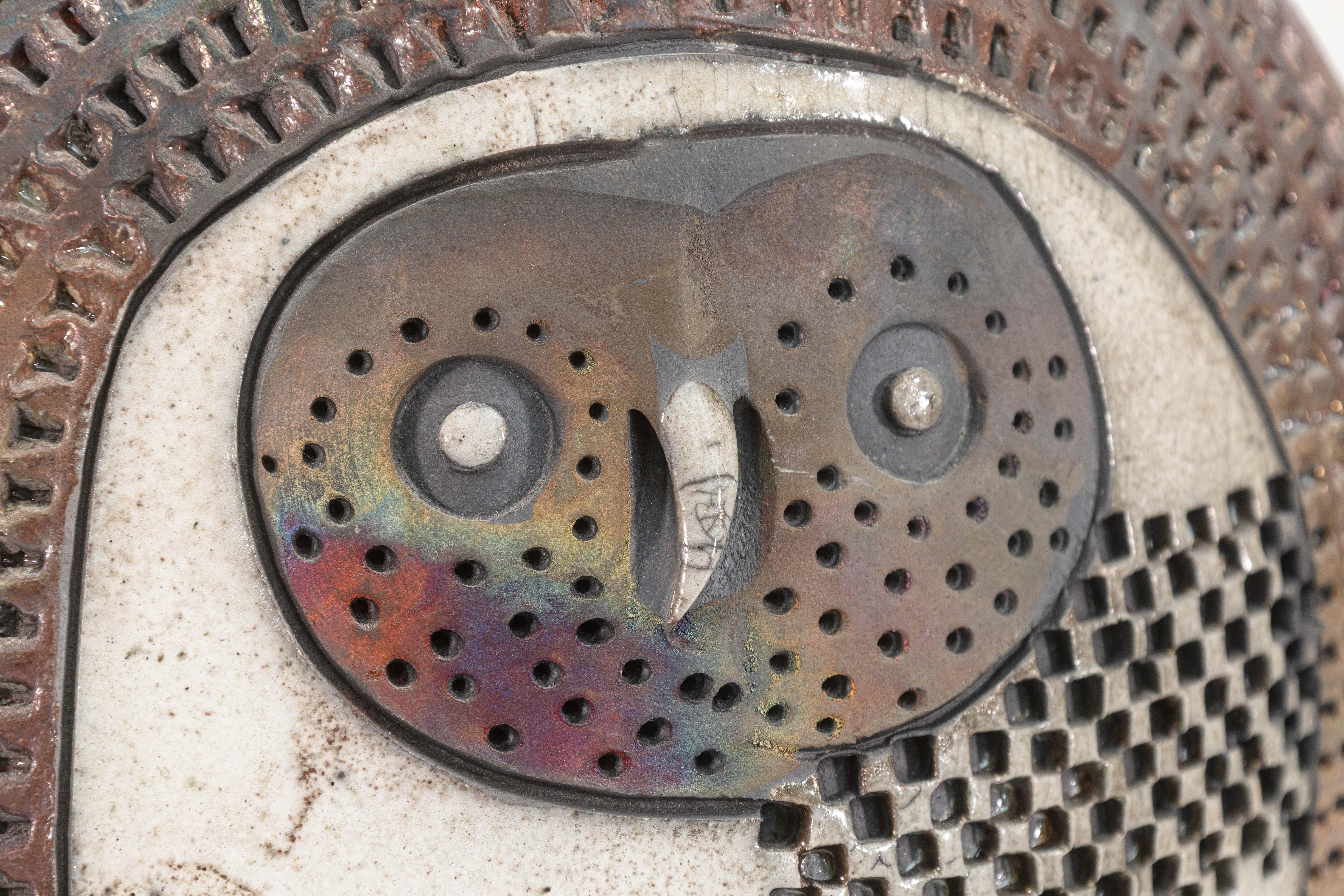 This expressive ceramic owl sculpture by Doug Delind is a striking example of Brutalist modern art fused with traditional Raku pottery techniques. Signed on underside. Circa 1990s.The stylized form captures the owl in a frontal pose, wings flared