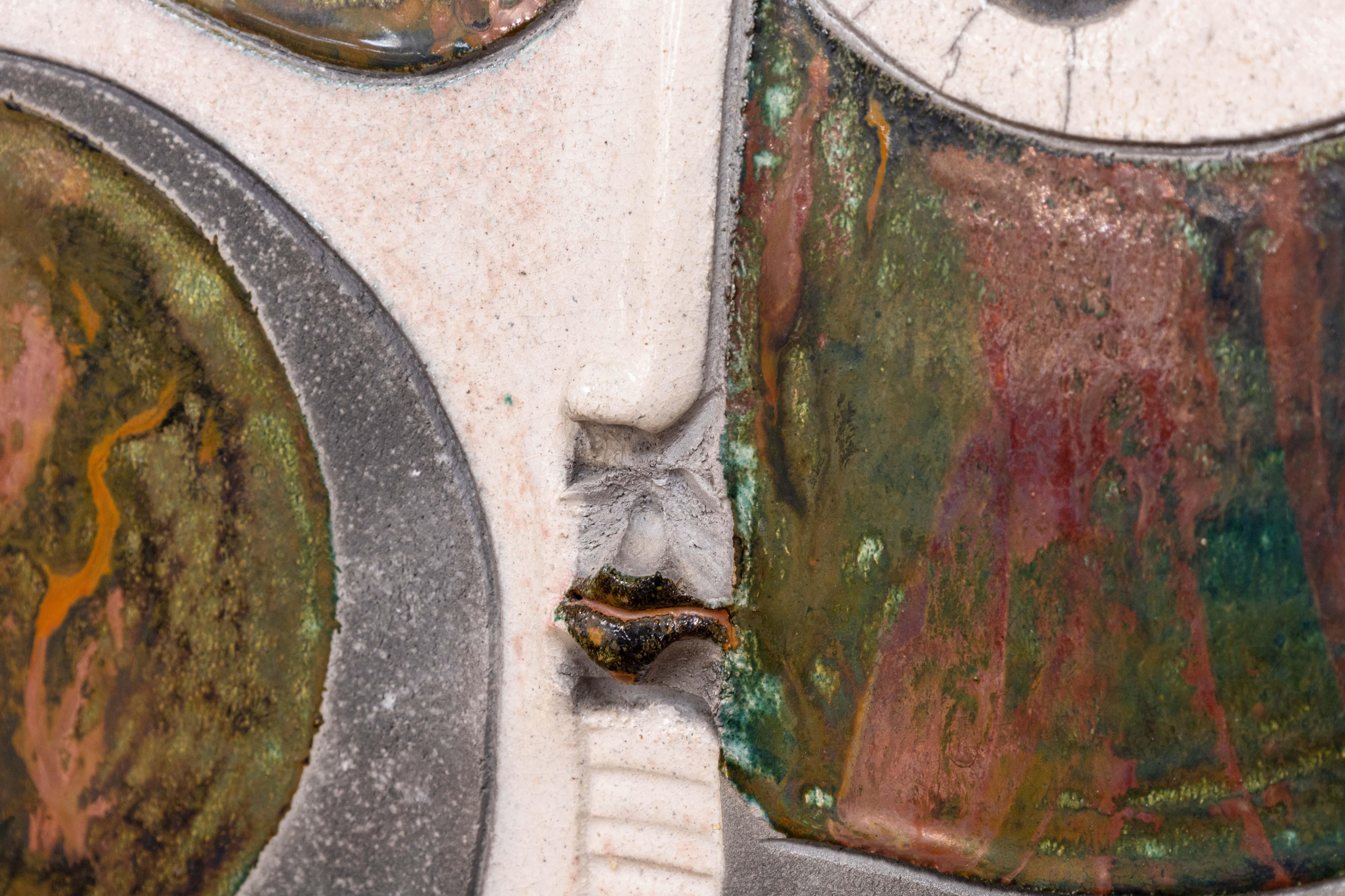 A postmodern studio pottery raku fired ceramic clay sculpture by Michigan artist Doug DeLind. Signed on bottom. Circa 1980s. A whimsical abstracted face in various glazes. The various shapes and curved lines are inspired by cubist art. A unique