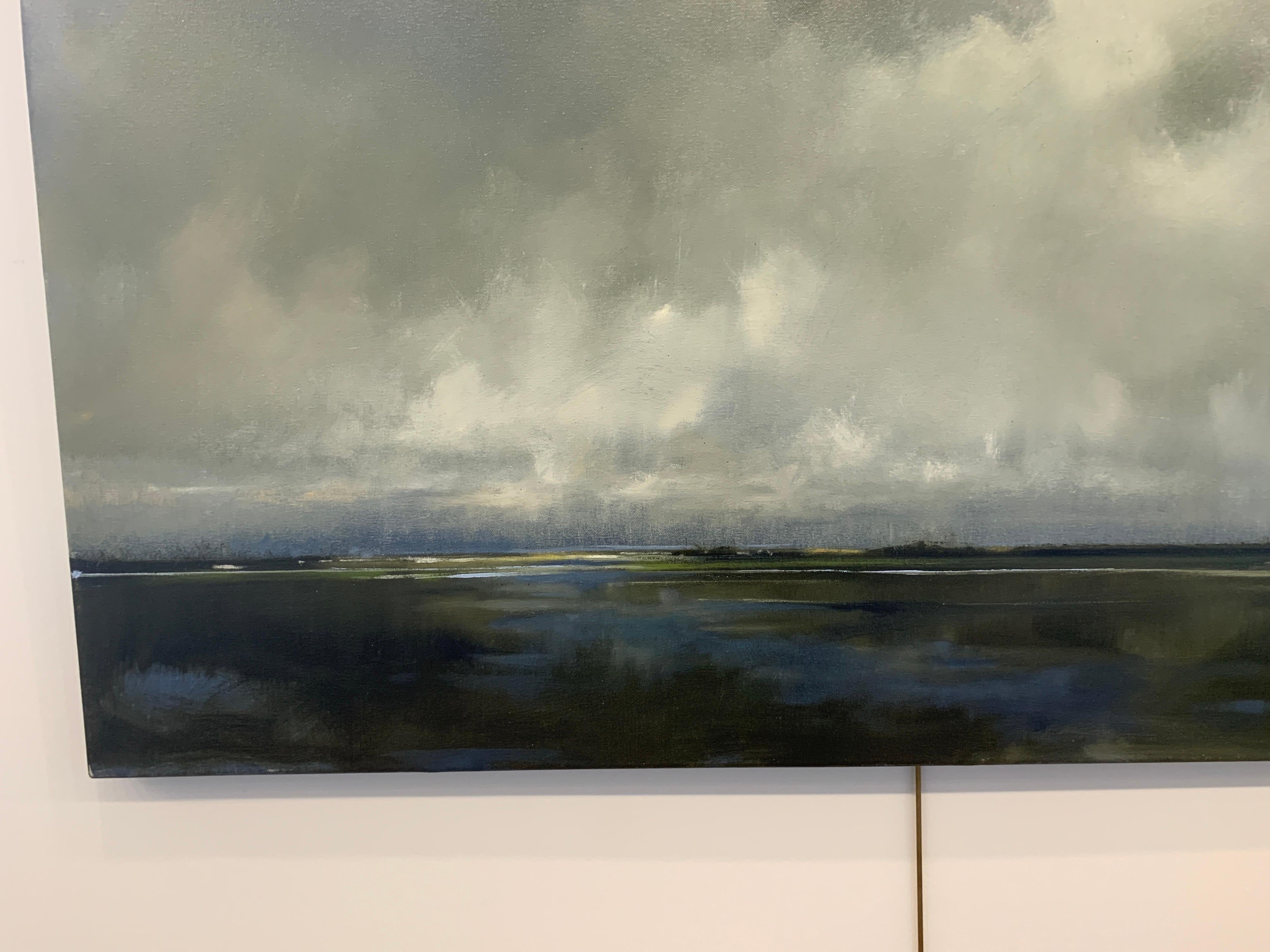 'Answer and Origin' is a large contemporary oil on canvas landscape painting created by American artist Doug Foltz in 2021. Featuring a palette made of grey, blue, white and greens among other tones, the painting depicts an exquisite marsh landscape