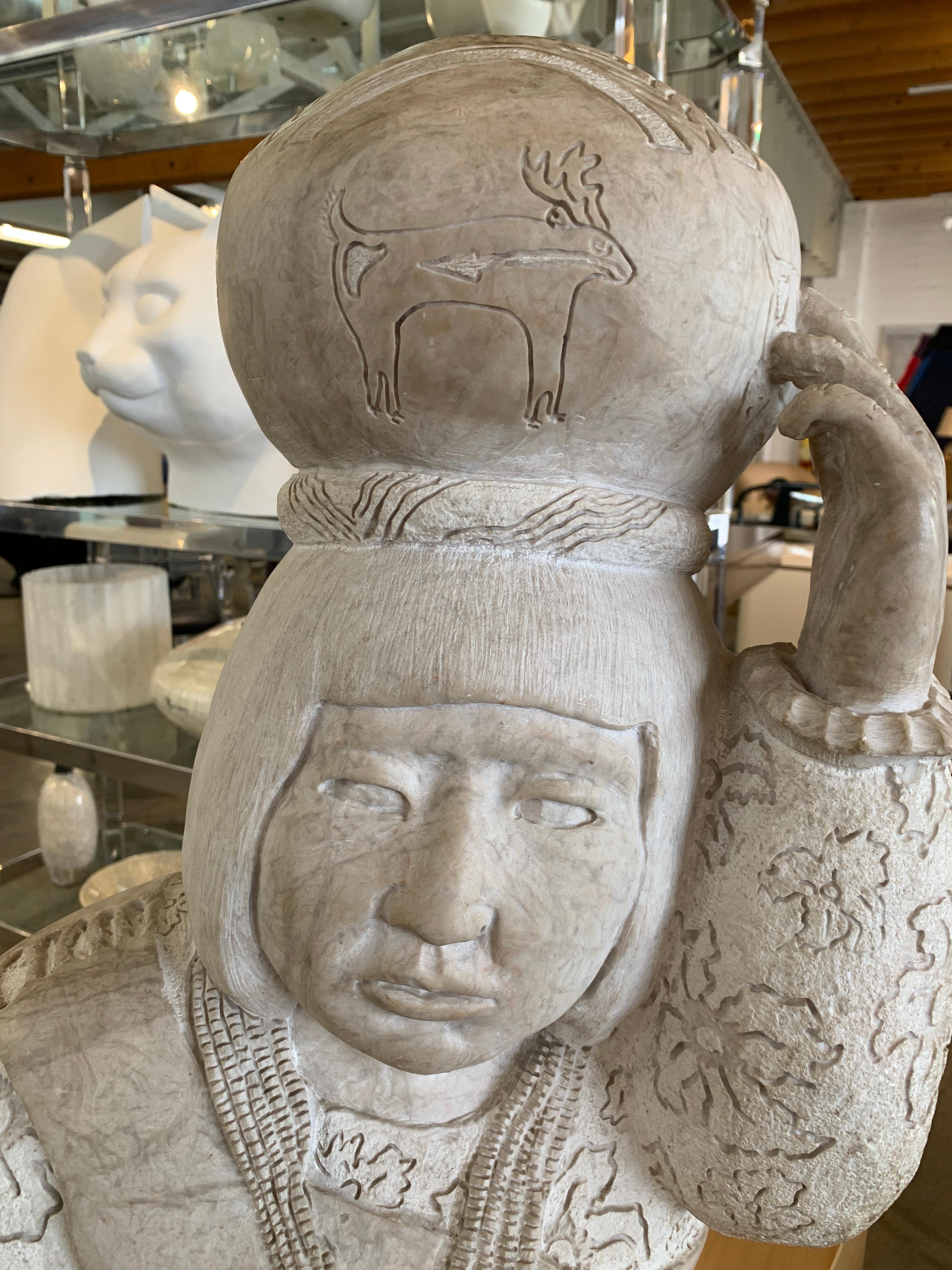 A large and impressive sculpture of an American Inuit with a basket on his head by Doug Hyde. This heavy piece is signed Doug Hyde and bears his seal. There is an old repair to the thumb, please see the detailed photographs. Nice overall incised