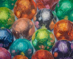 Muchos Chocolates, coloridos caramelos de chocolate envueltos en papel de aluminio con reflejos