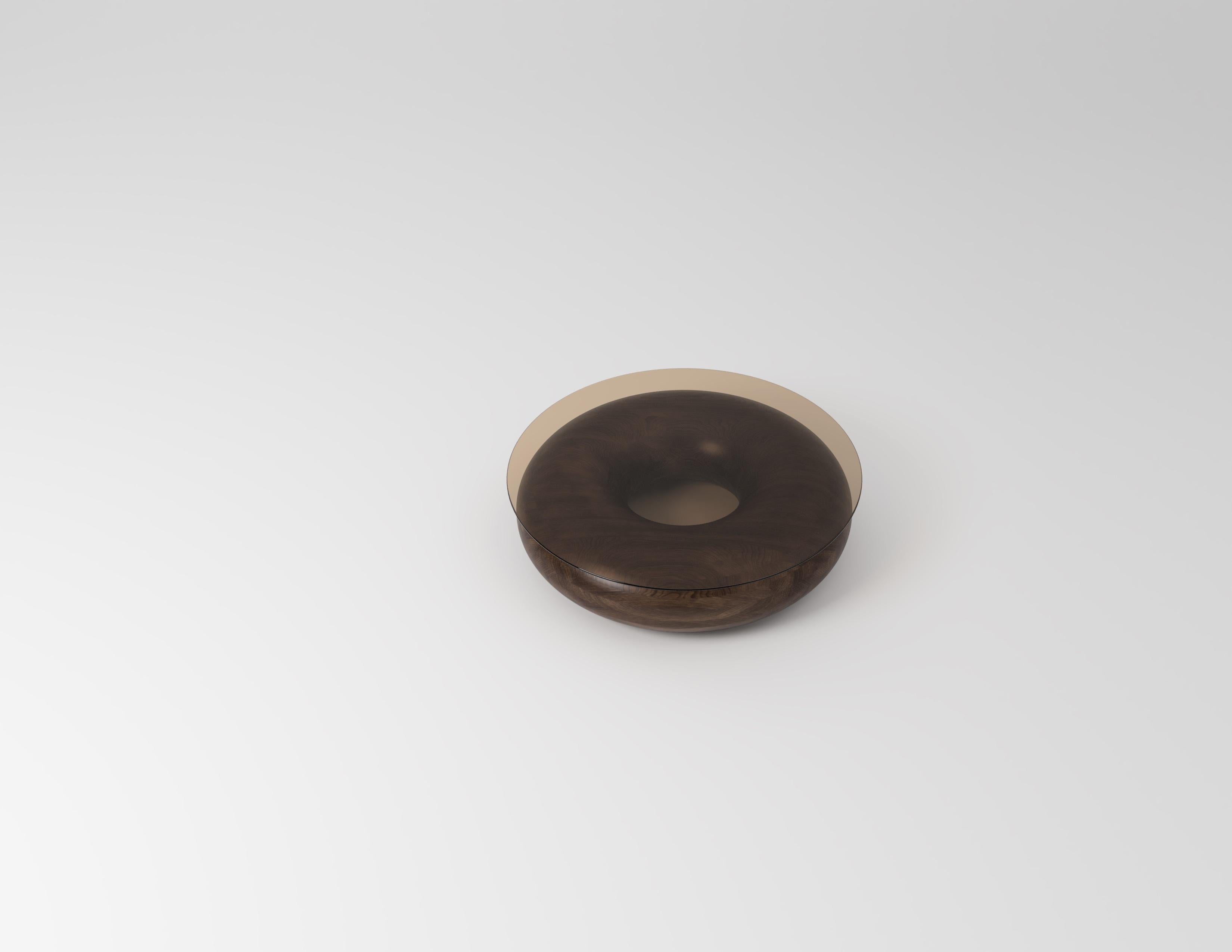 Made-to-order
Doughnut walnut with bronze glass top
Coffee table by Johan Wilén

A true testament to the designer’s signature style, redefining what we understand as the beauty of simplicity. Exquisite solid wood base with bronze glass top,