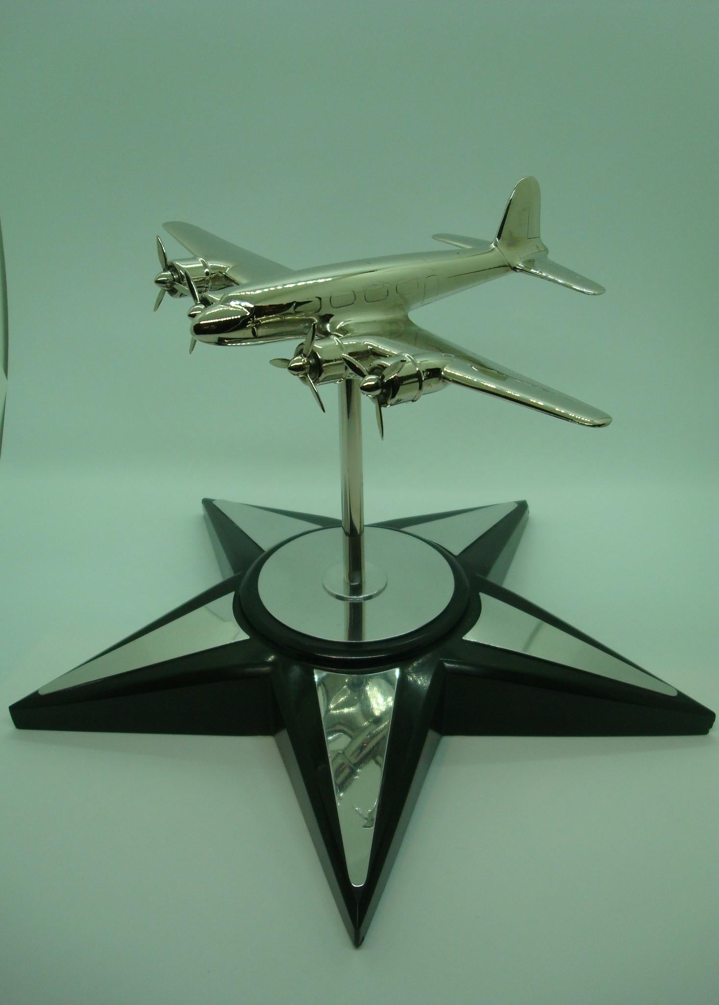 Art Deco Douglas DC4 Aviation desk model. Mounted over a marble star.
Airplane is adjustable in different positions.
 