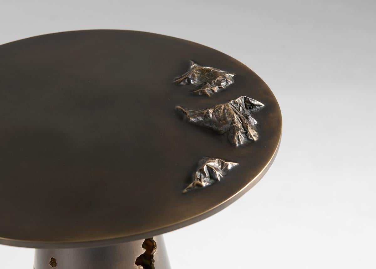 Master metalsmith Douglas Fanning's small round side table features a series of topographical crests that rise from its otherwise smooth top. Further 