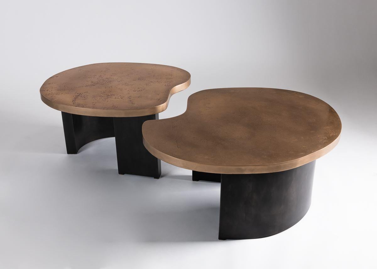 Douglas Fanning's unique Bean table has an amorphous, dappled bronze top and rests upon curved, blackened steel legs. This beautifully abstract creation functions with an elegant simplicity befitting its form, pulling apart into two modular pieces.