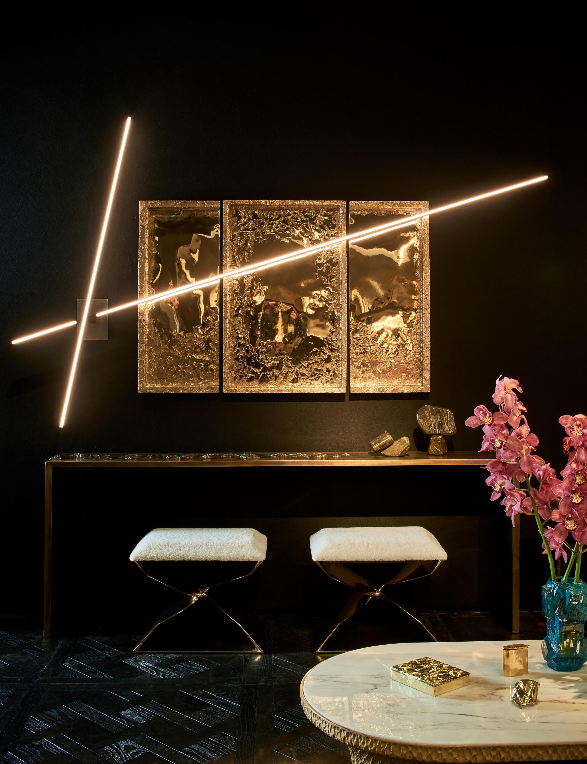 An ingenious sconce made of two intersecting wands of brushed bronze and glass encased LEDs, designed to rotate on a common axis. An impeccable work of industrial, functional beauty, the sconce serves as an excellent example of Fanning's deep