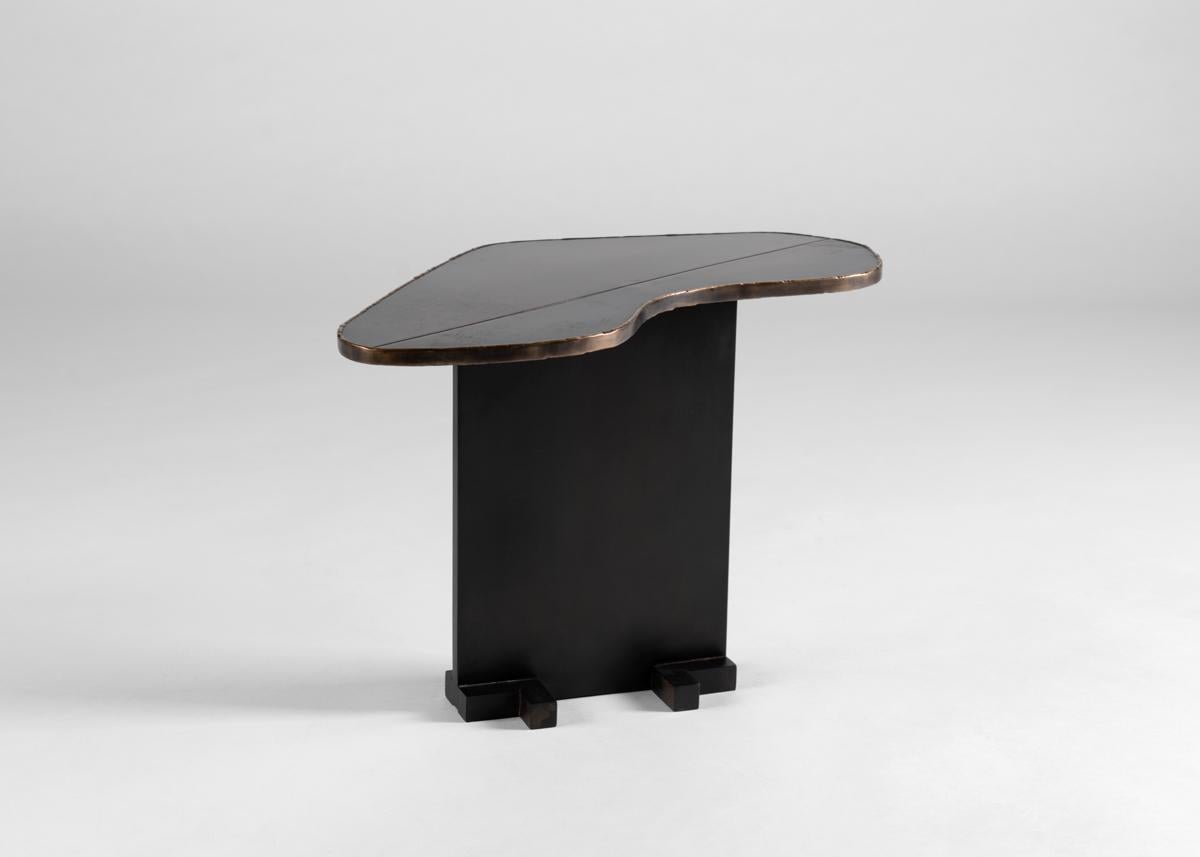 This table top's amorphous shape is in fact that of a heart, its beautiful cast bronze surface bisected by a clean seam stretching from its two farthest points.

Douglas Fanning received a Masters in Architecture from Columbia University in 1994. In