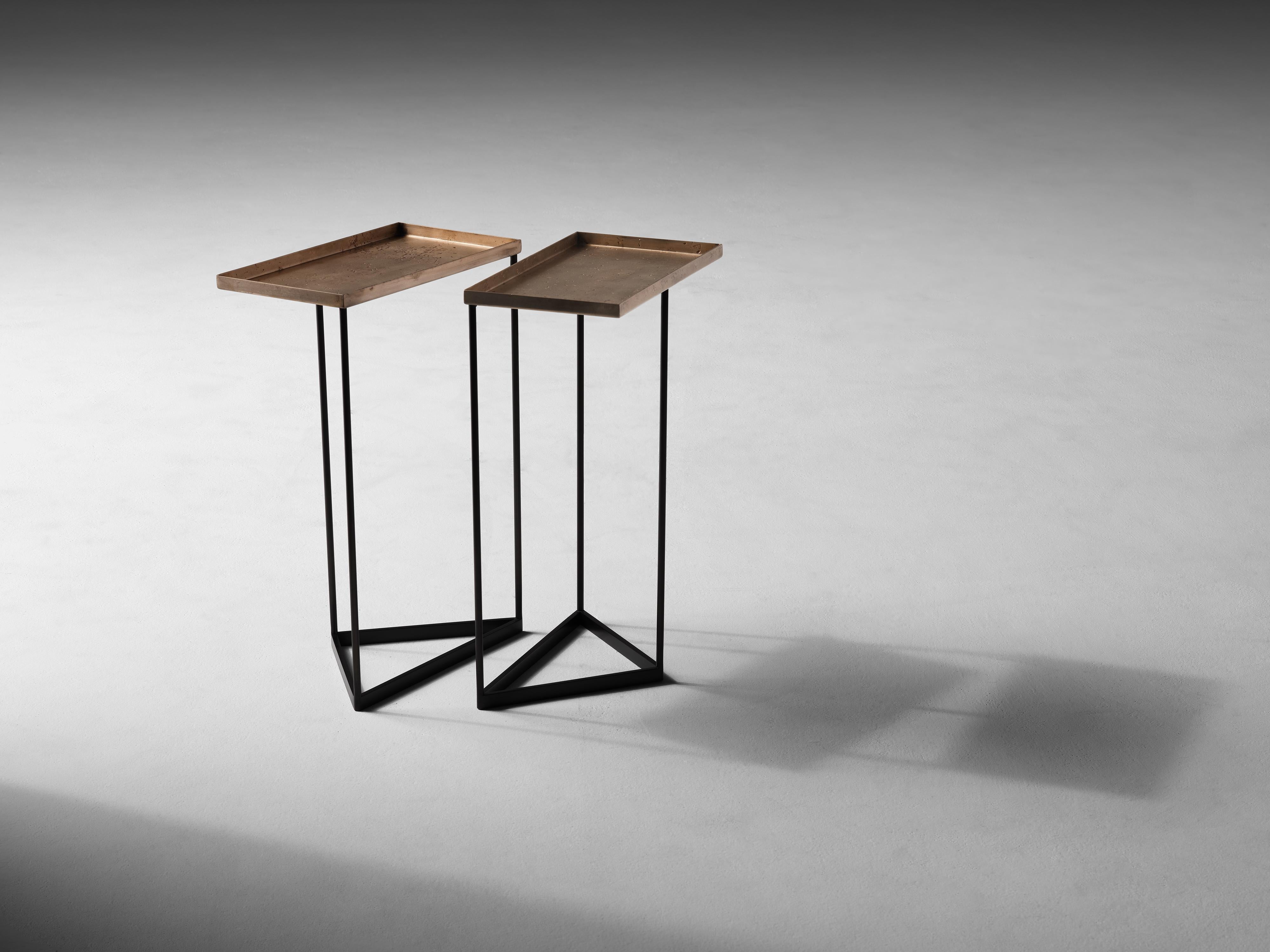 This geometric side table, an industrial arrangement of complementary square and triangular corners rests upon cold blackened steel, and features a sunken top of warm bronze.

Douglas Fanning received a Masters in Architecture from Columbia